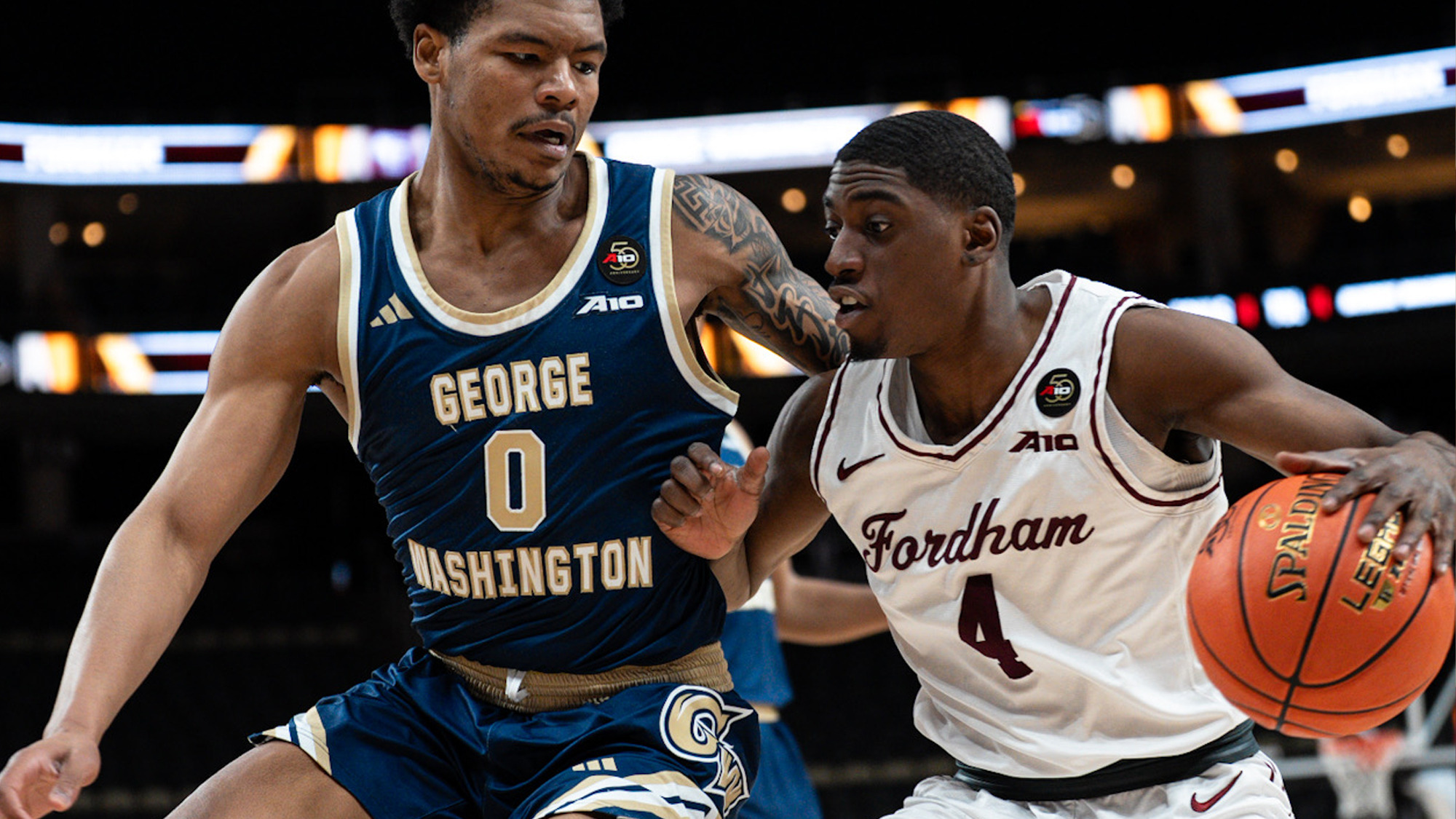Marcus Greene drives against GW at the A-10 Championship