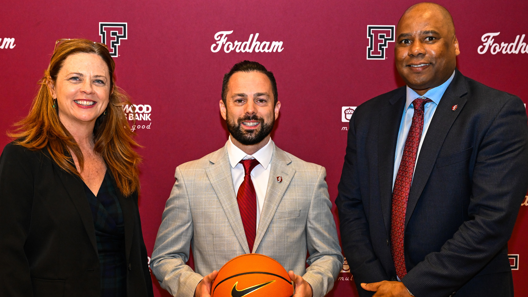 University president Tania Tetlow, women's head basketball cocah Neil Harrow, and Director of Athletics Charles Guthrie