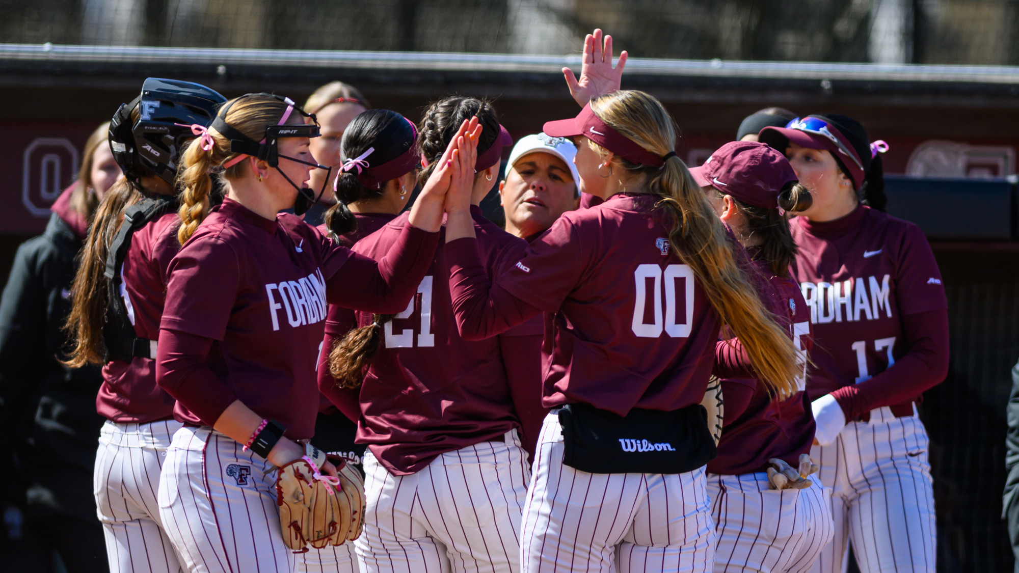 Fordham softball huddles during St. John's game