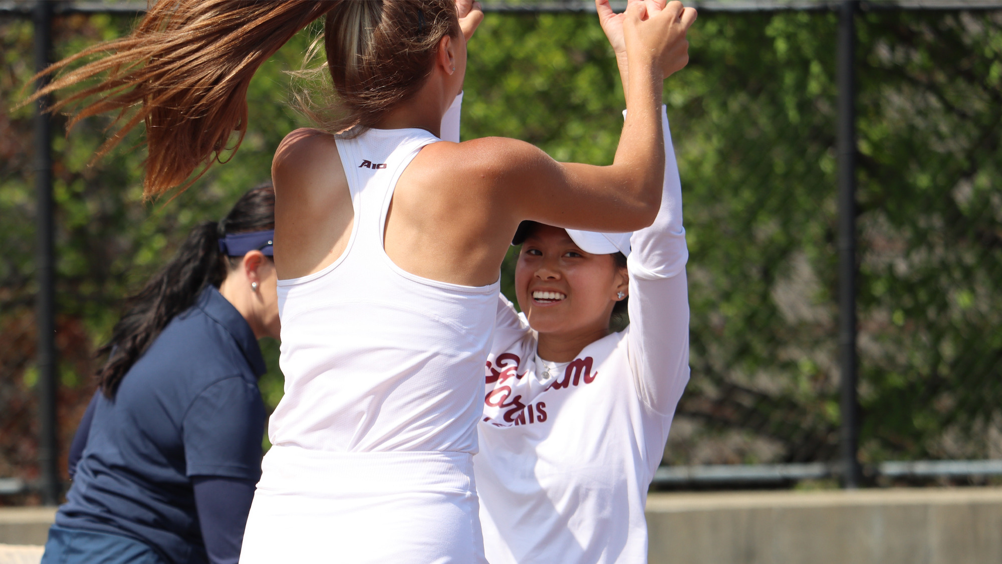 Lily Chitambar and Julianne Nguyen celebrate Fordham's win over URI