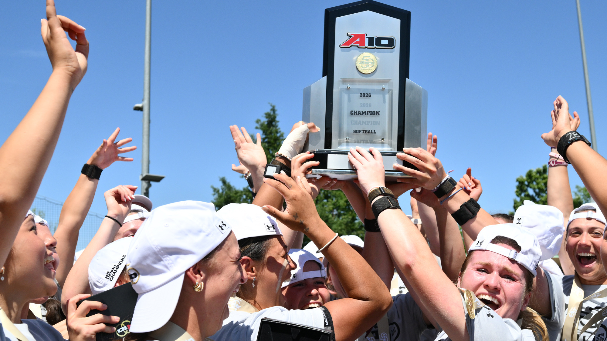 The 2026 Softball Rams celebrate with the A-10 trophy