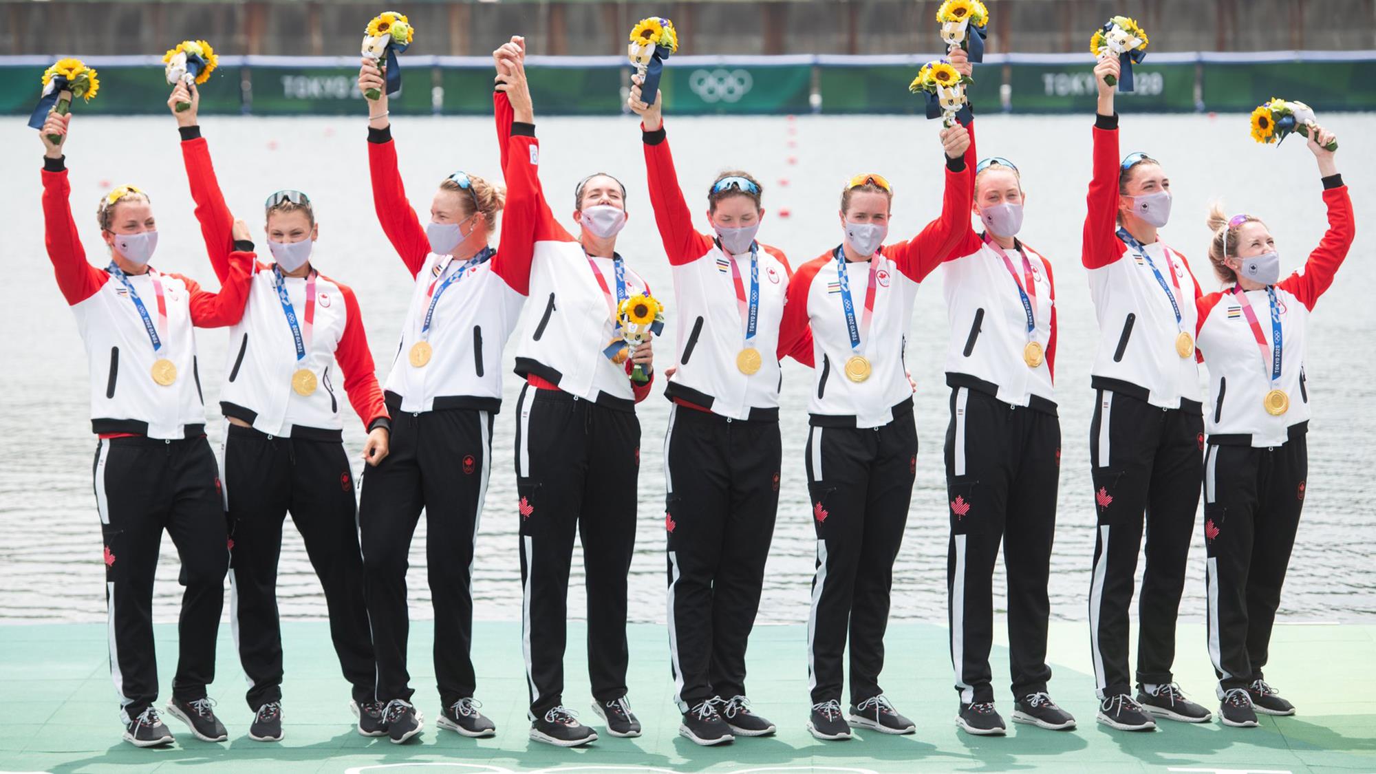 Lisa Roman (left) and Team Canada women's eight celebrate their Olympic gold medal
