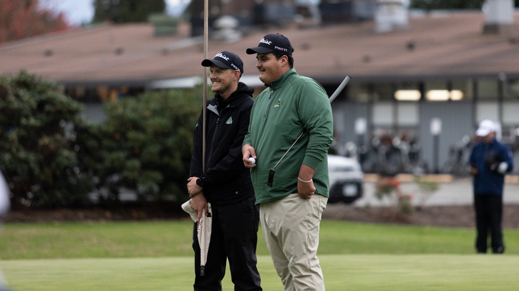 Hayden Lazeo talks with coach Greene on the 18th green of the CW golf championship op[ening round