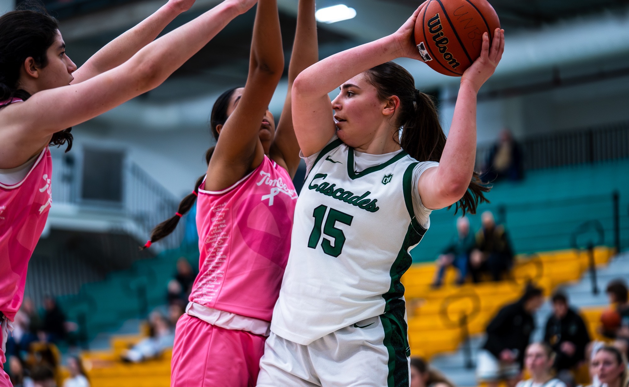 Jessica Parkinson holds the ball away from a pair of UNBC defenders