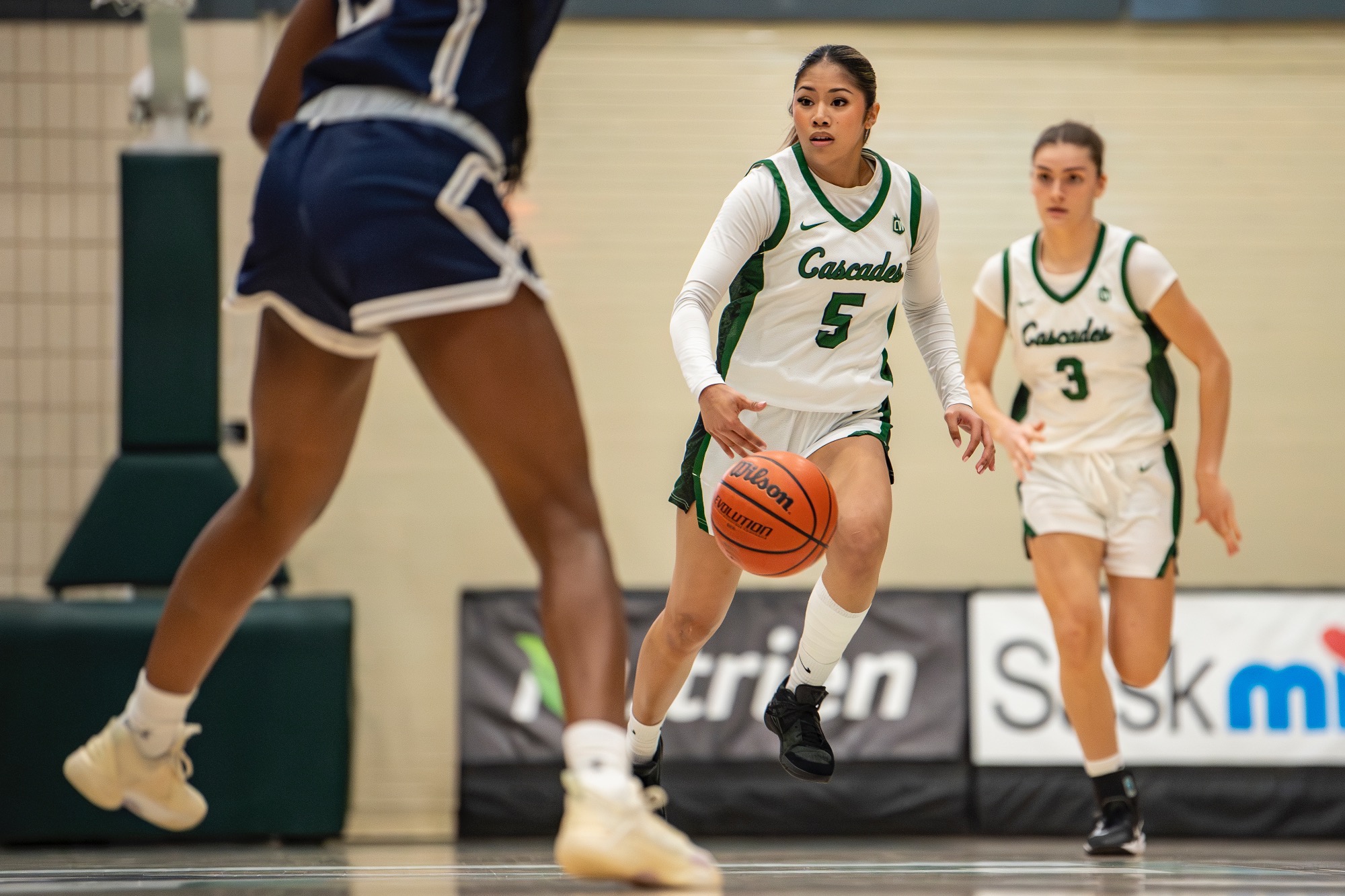 Bernie Leda carries the ball with Miah Schuurman following