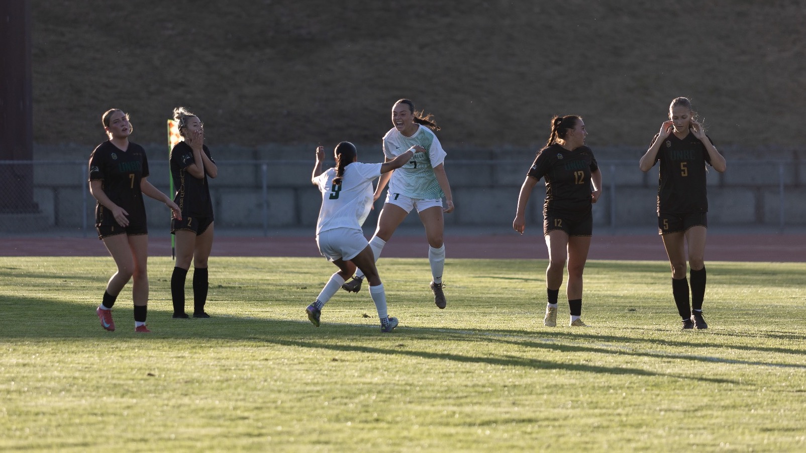 Emerson Toop celebrates her winning goal with Eesha Mudaliar