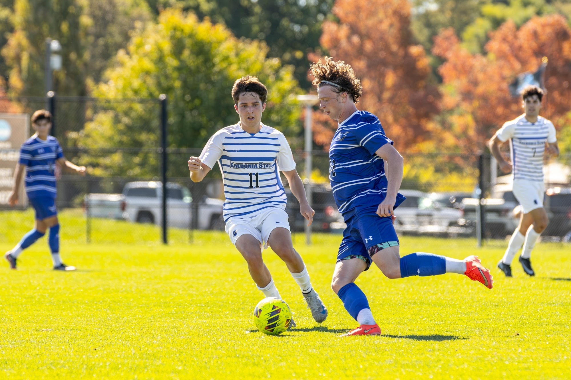 Sam Evans defends during men's soccer action against Alfred State