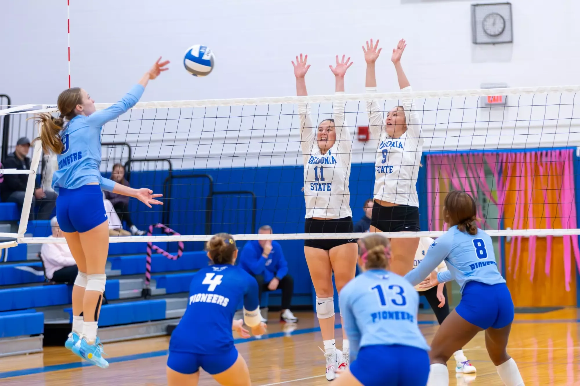Maeve Musielak and Cayla Partsch ready to block the ball. 