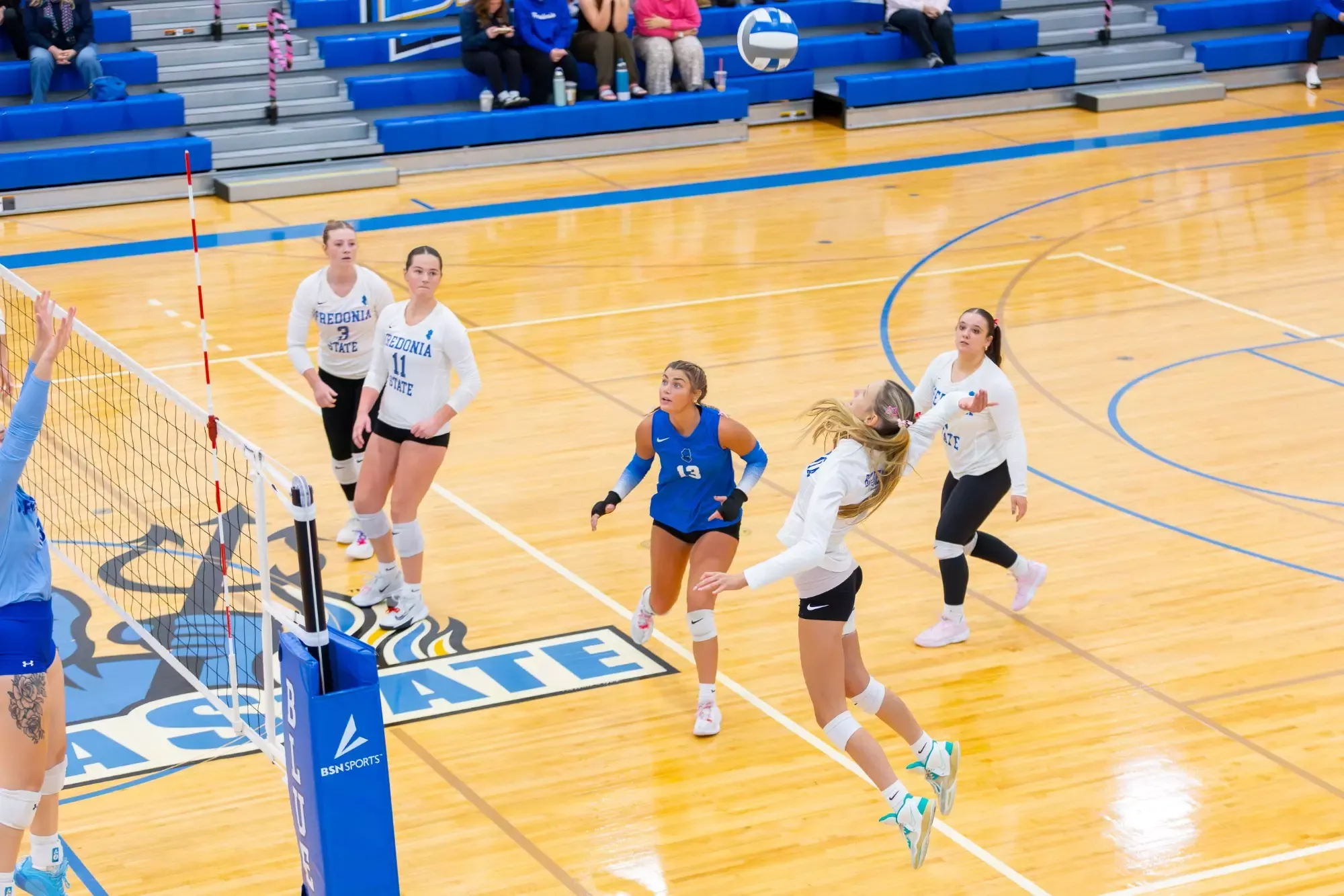 Logann Lexner hitting the ball in the air. 