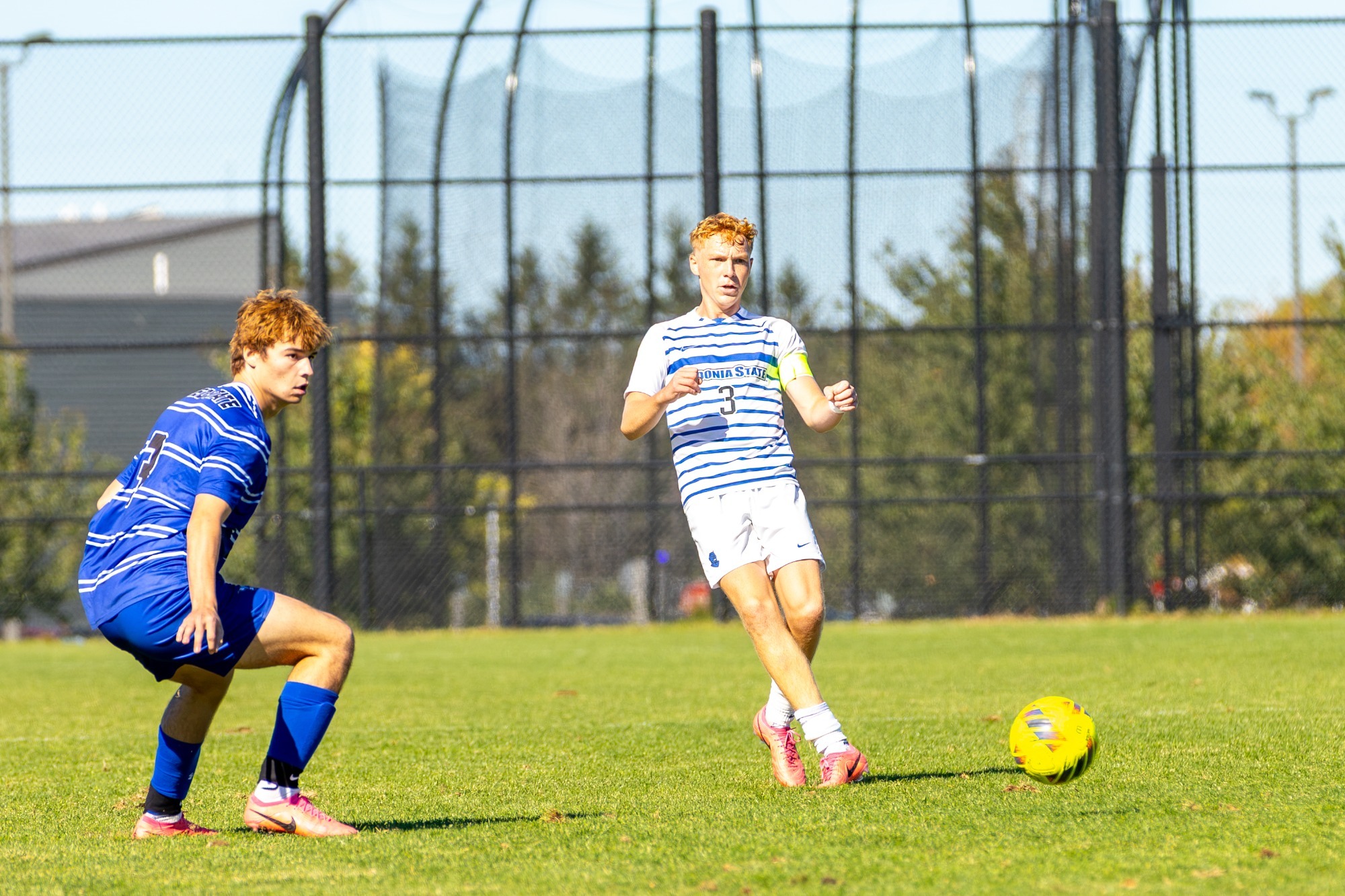 Brendan Adams passes the ball during men's soccer against Alfred State