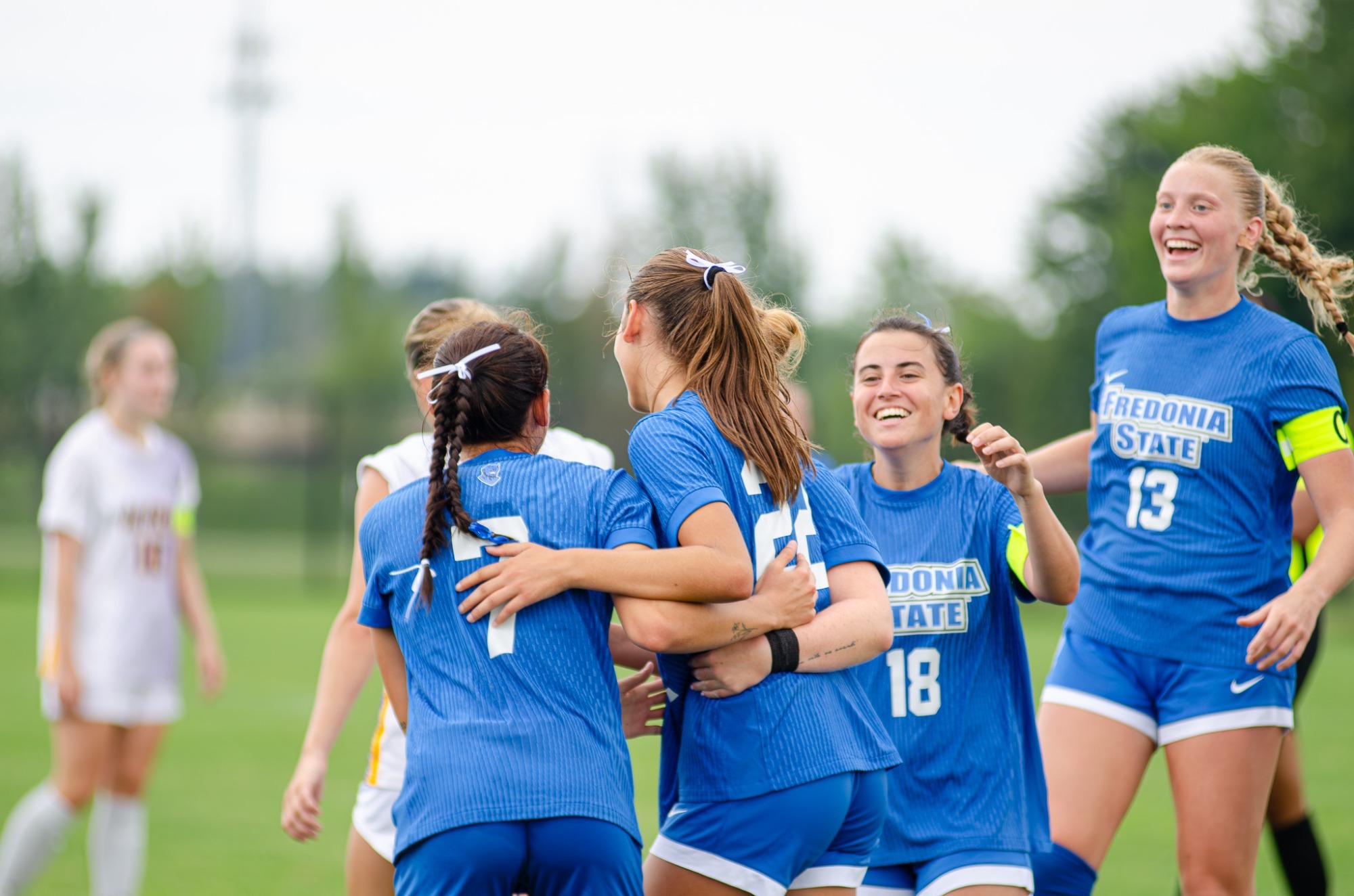 Members of the Fredonia State women's soccer team celebrate a goal during their win over Alfred U.