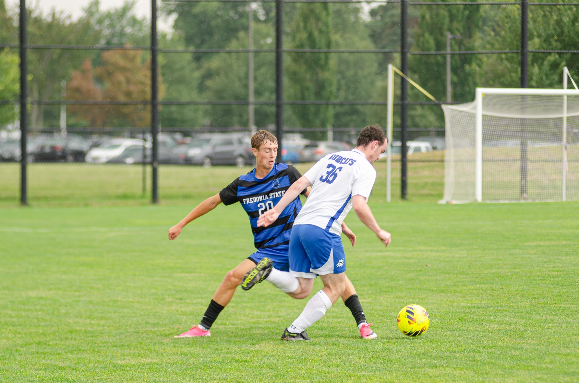 Jackson Kuby defends a Bryant and Stratton player during Fredonia State men's soccer action