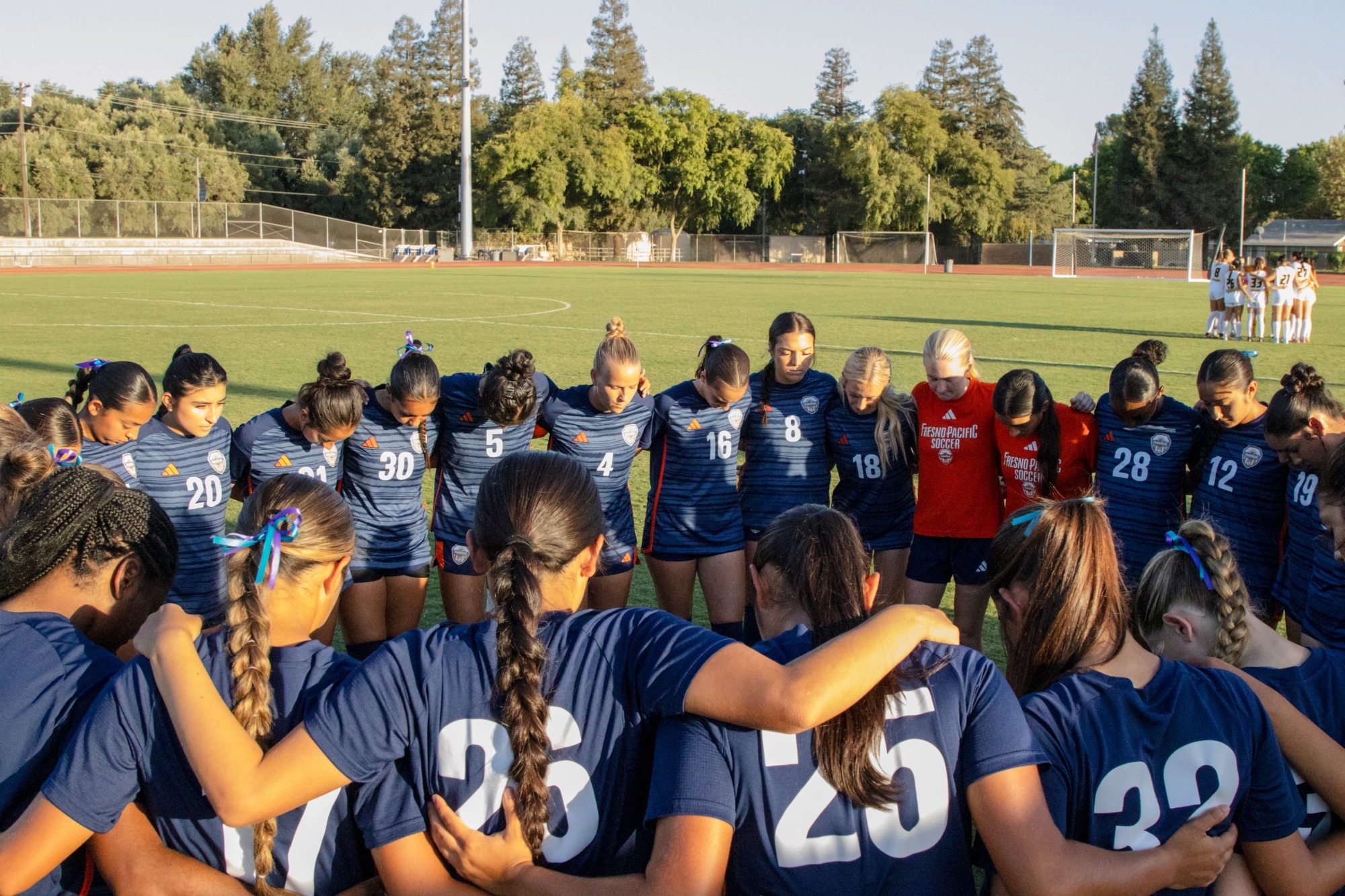 womens soccer team in huddle 2026