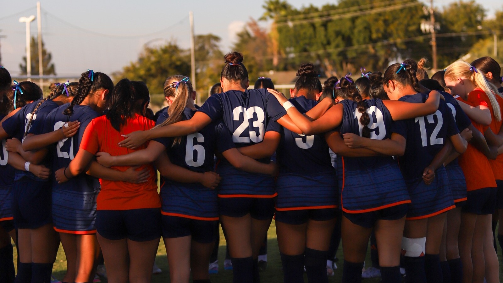 women's soccer huddling at home game