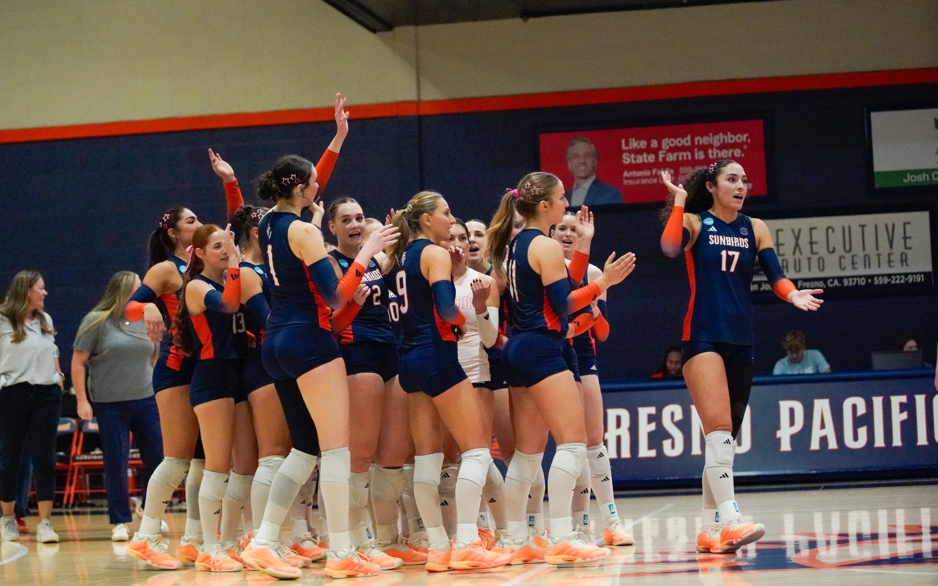 womens volleyball cheering at end of the game