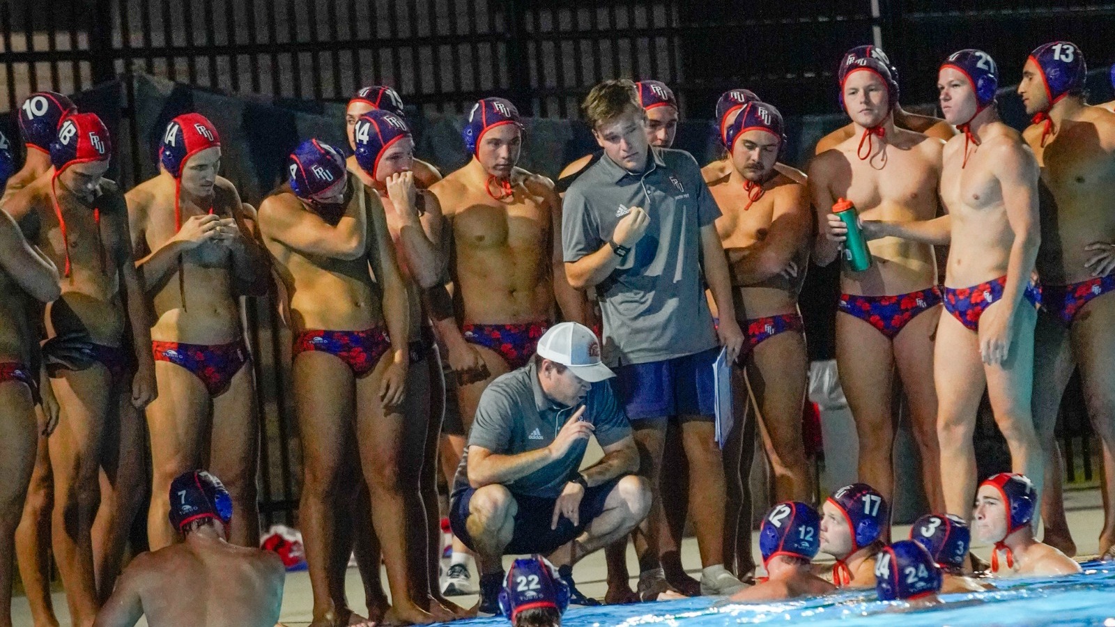 mens water polo team huddle