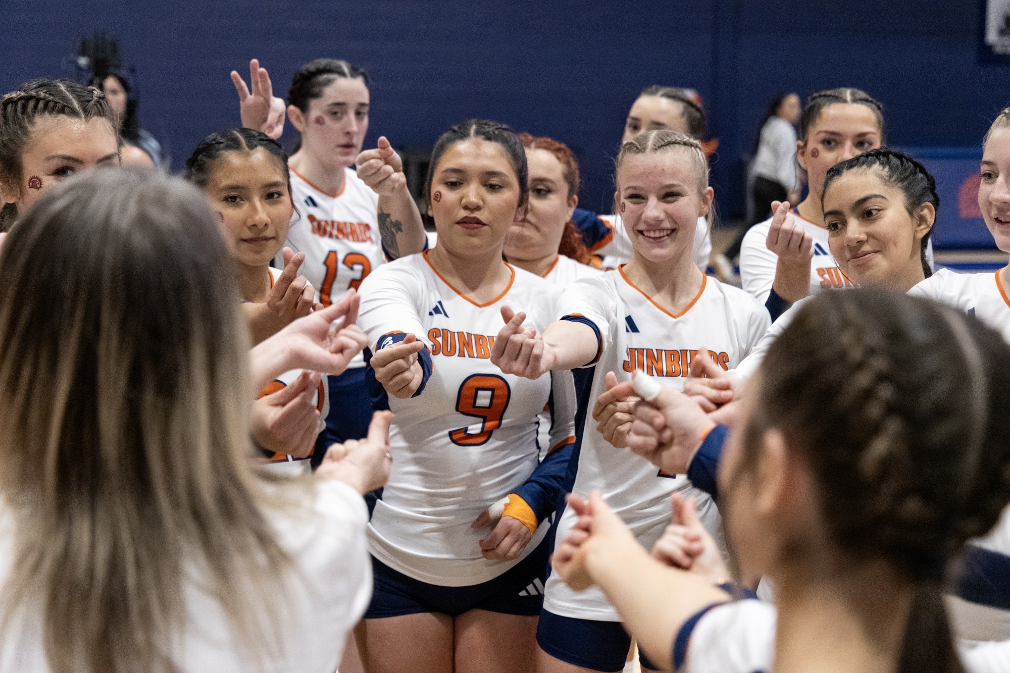 stunt team in huddle