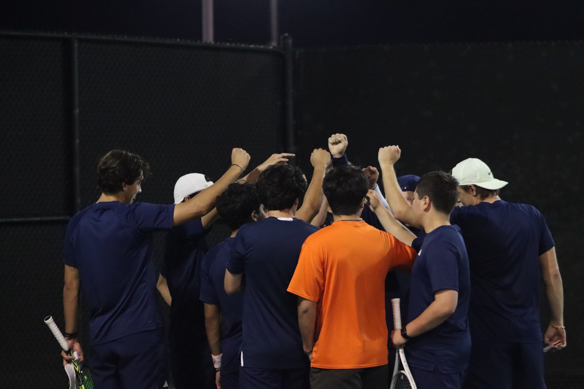 mens tennis in huddle