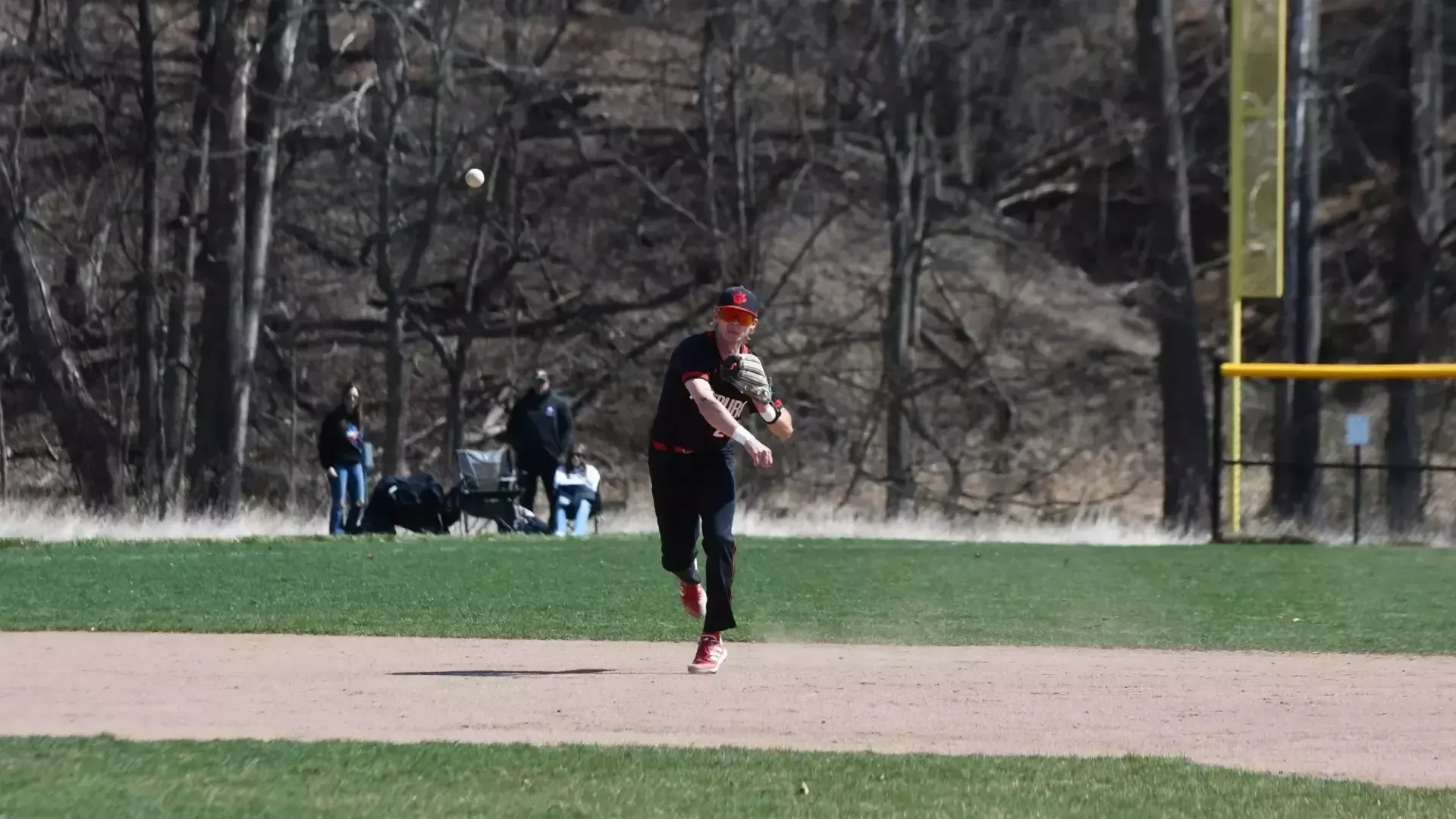 Frostburg Baseball infielder, number 25, CJ Carmichael, throwing baseball. 
