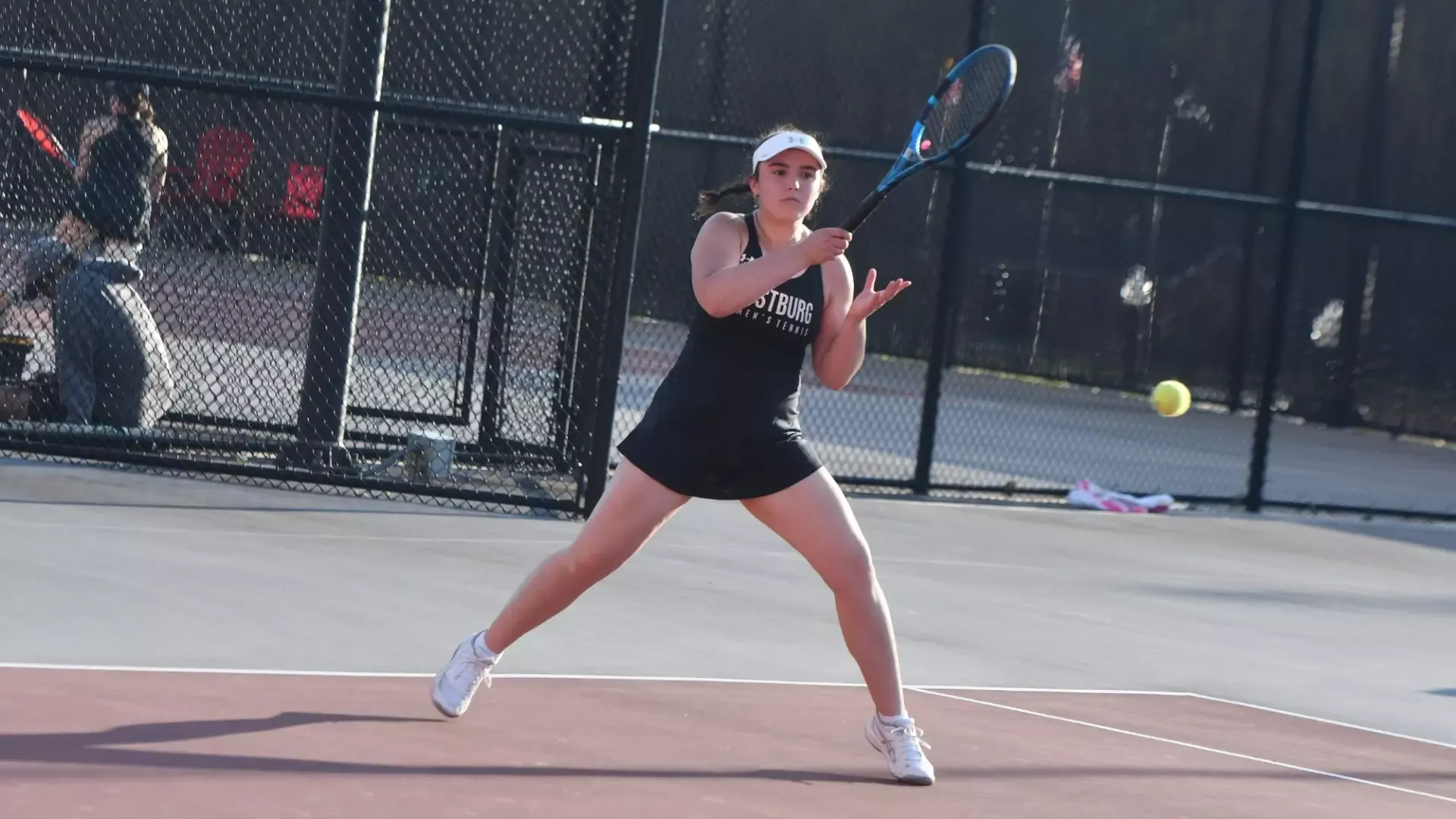 Frostburg women's tennis player, Ella Troxell returns with a forehand hit.