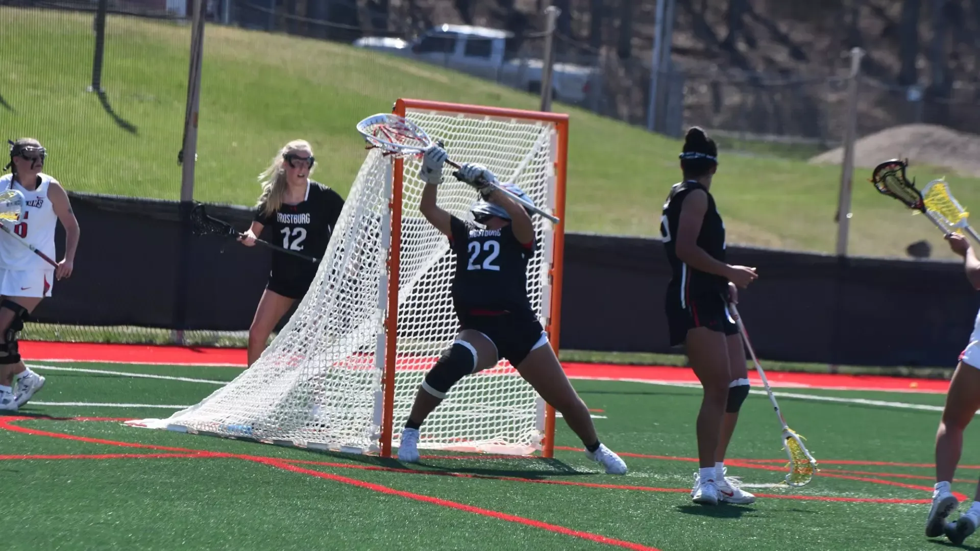 Frostburg women's lacrosse goal keeper, number 22, Liz Amos, saves shot versus Davis and Elkins.