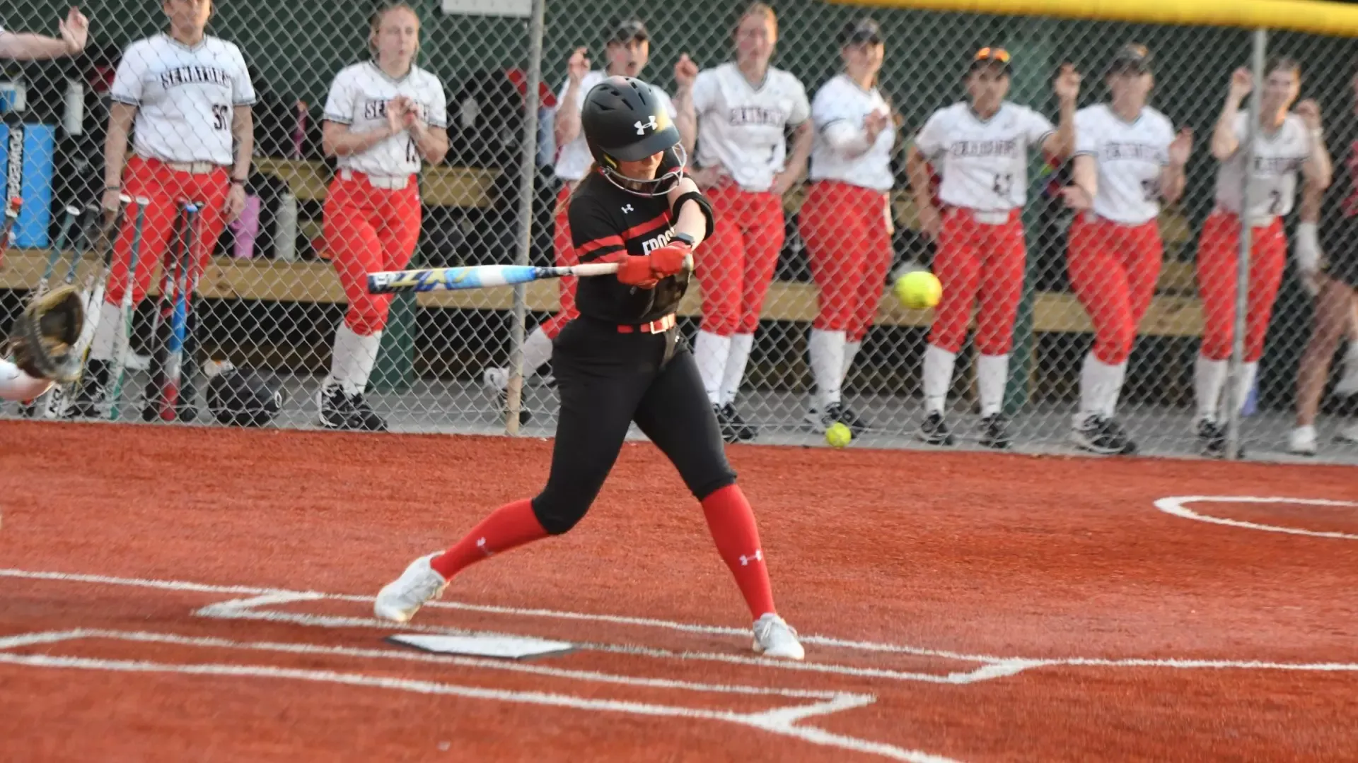Frostburg softball player, number 42, Sammy Magee, bat swing at home plate.