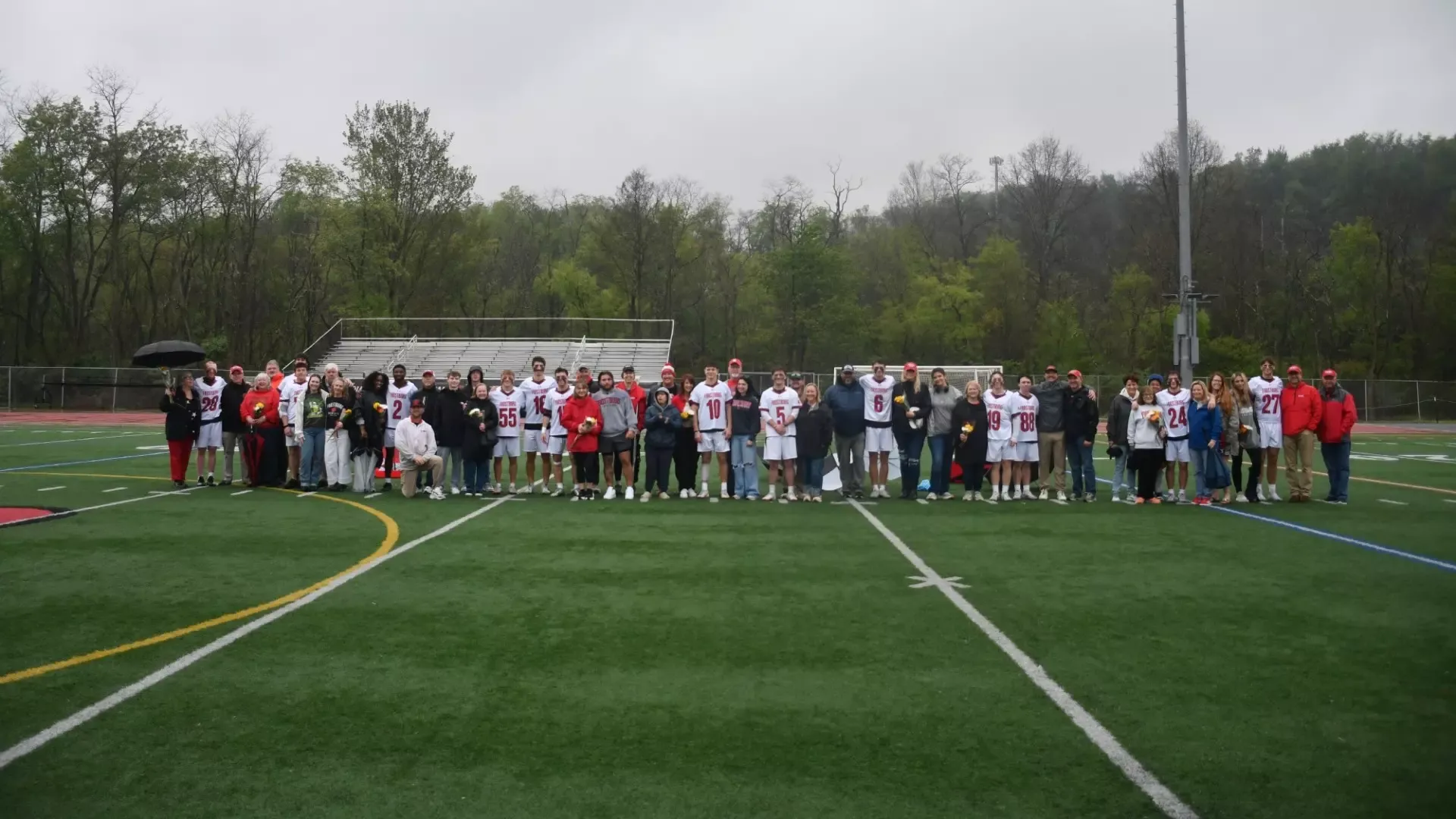 Frostburg men's lacrosse seniors, stand together with their families.