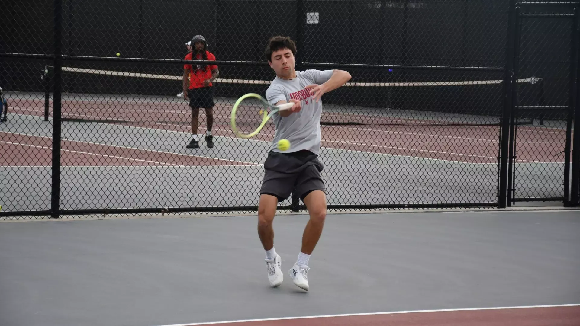 Frostburg Men's tennis player, Cole Alcala, hitting a forehand hit.