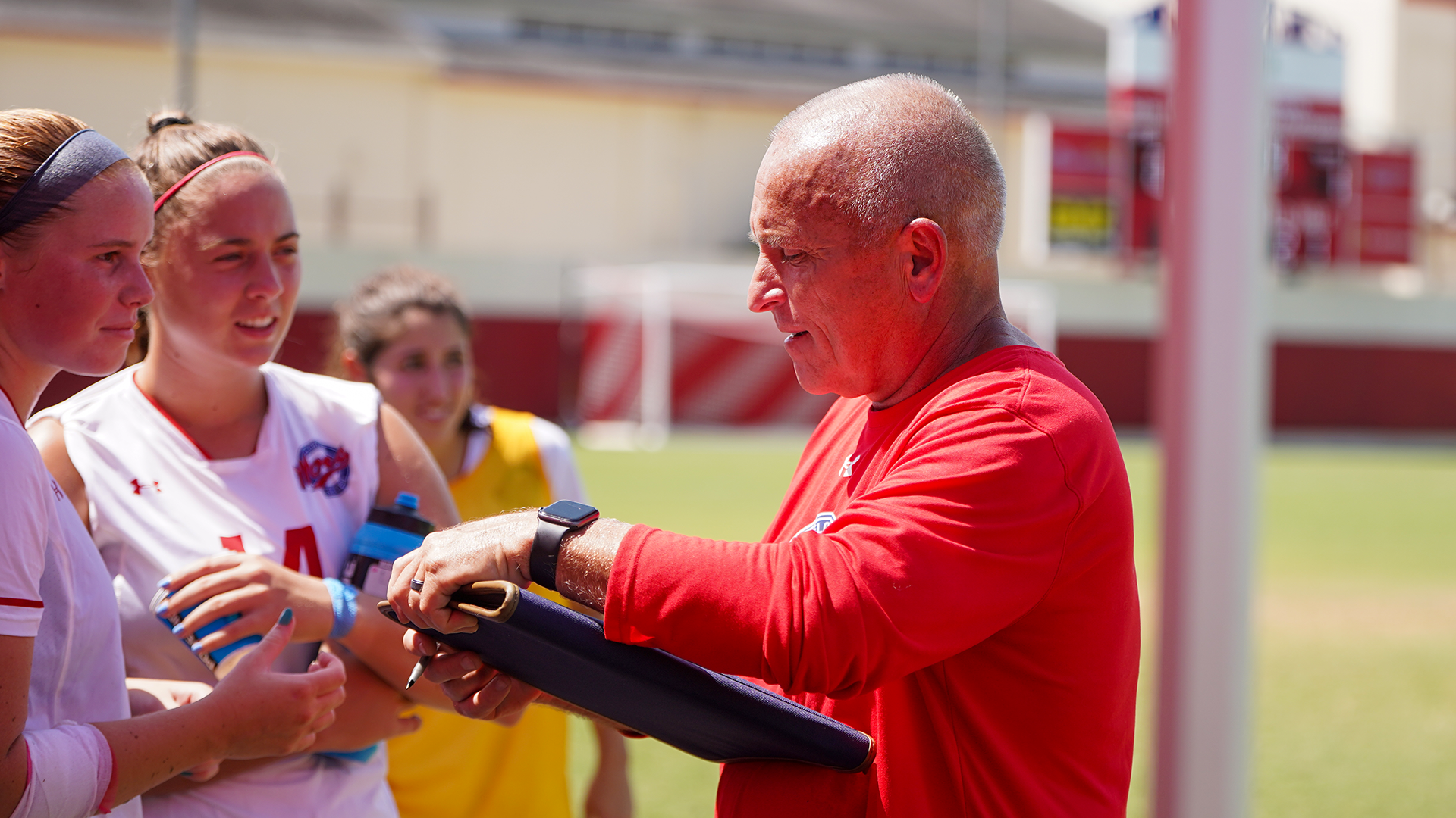Lucey coaching players on sideline