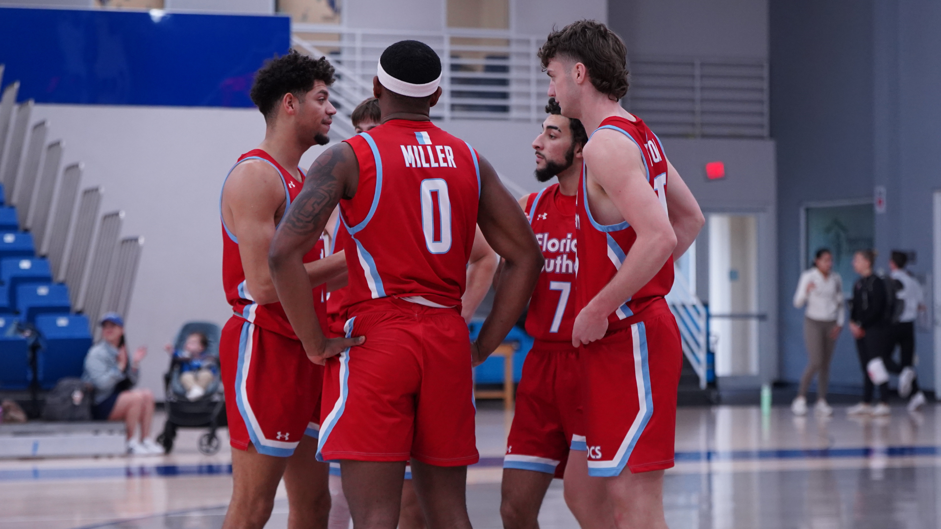 Men's basketball huddle at Lynn