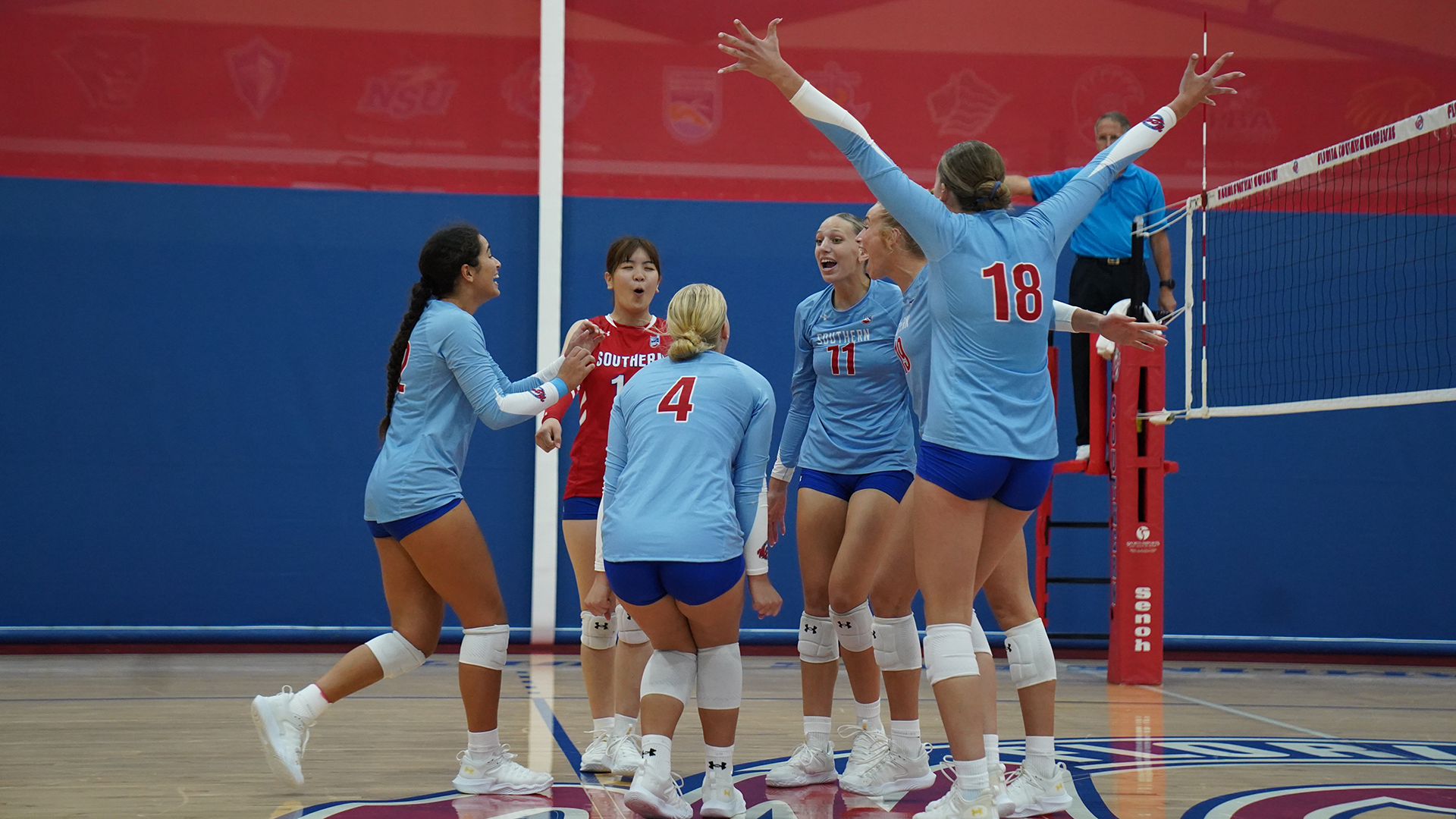 Volleyball celebrating a point versus Hillsdale