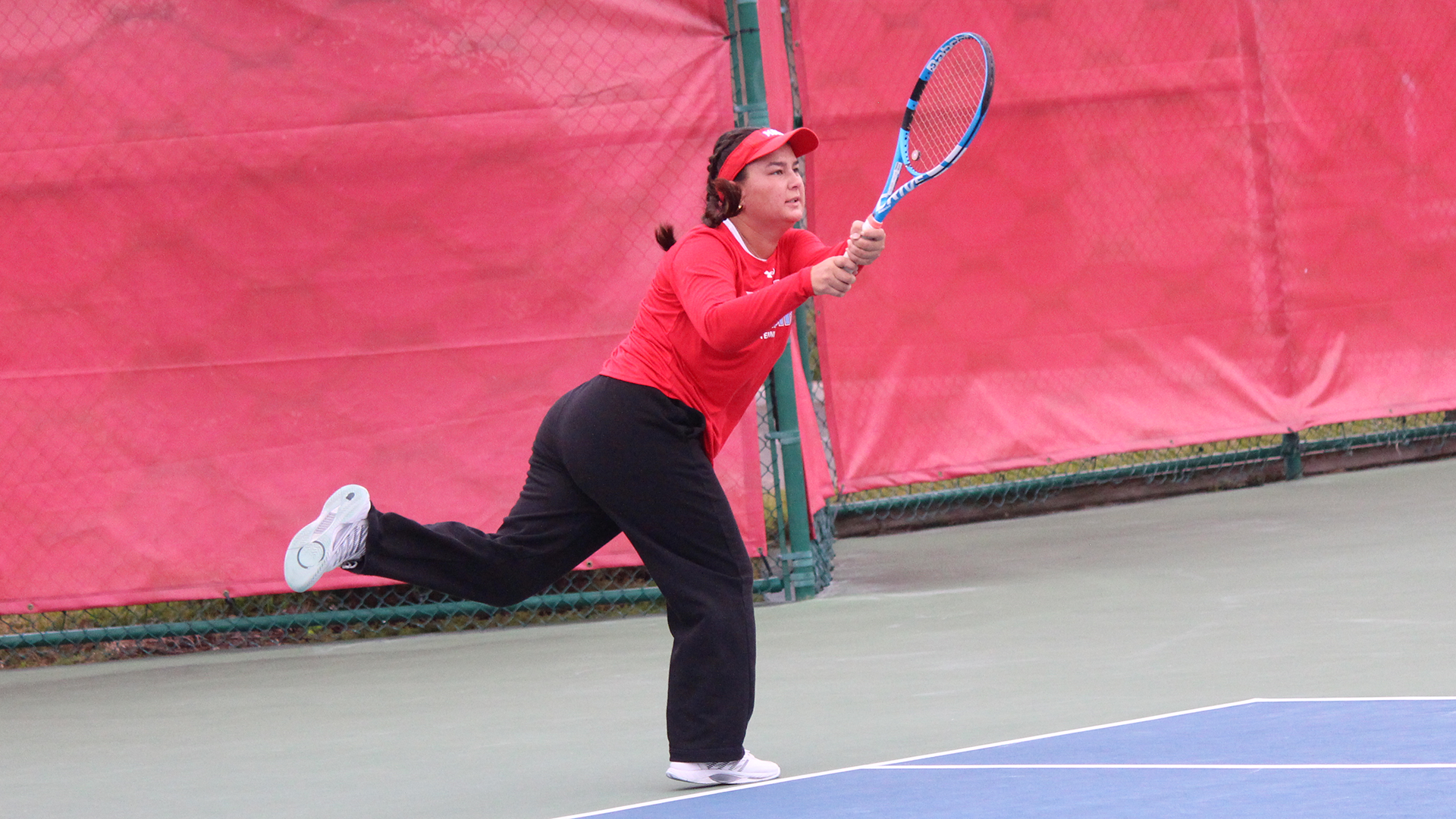 Emily Jennewein hitting the tennis ball option for vs Rollins