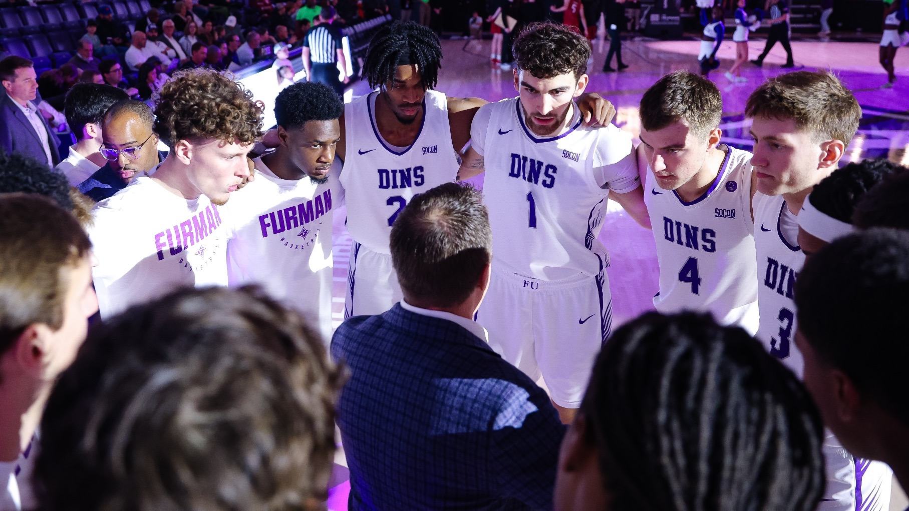 Furman Team Huddle Versus Harvard