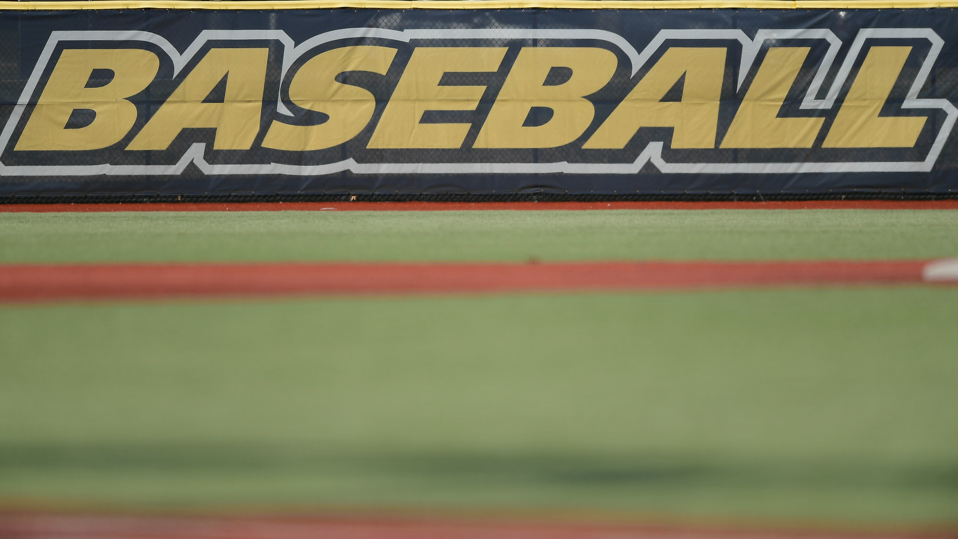 Hoy Field - Outfield fence with the word BASEBALL in all caps at the top