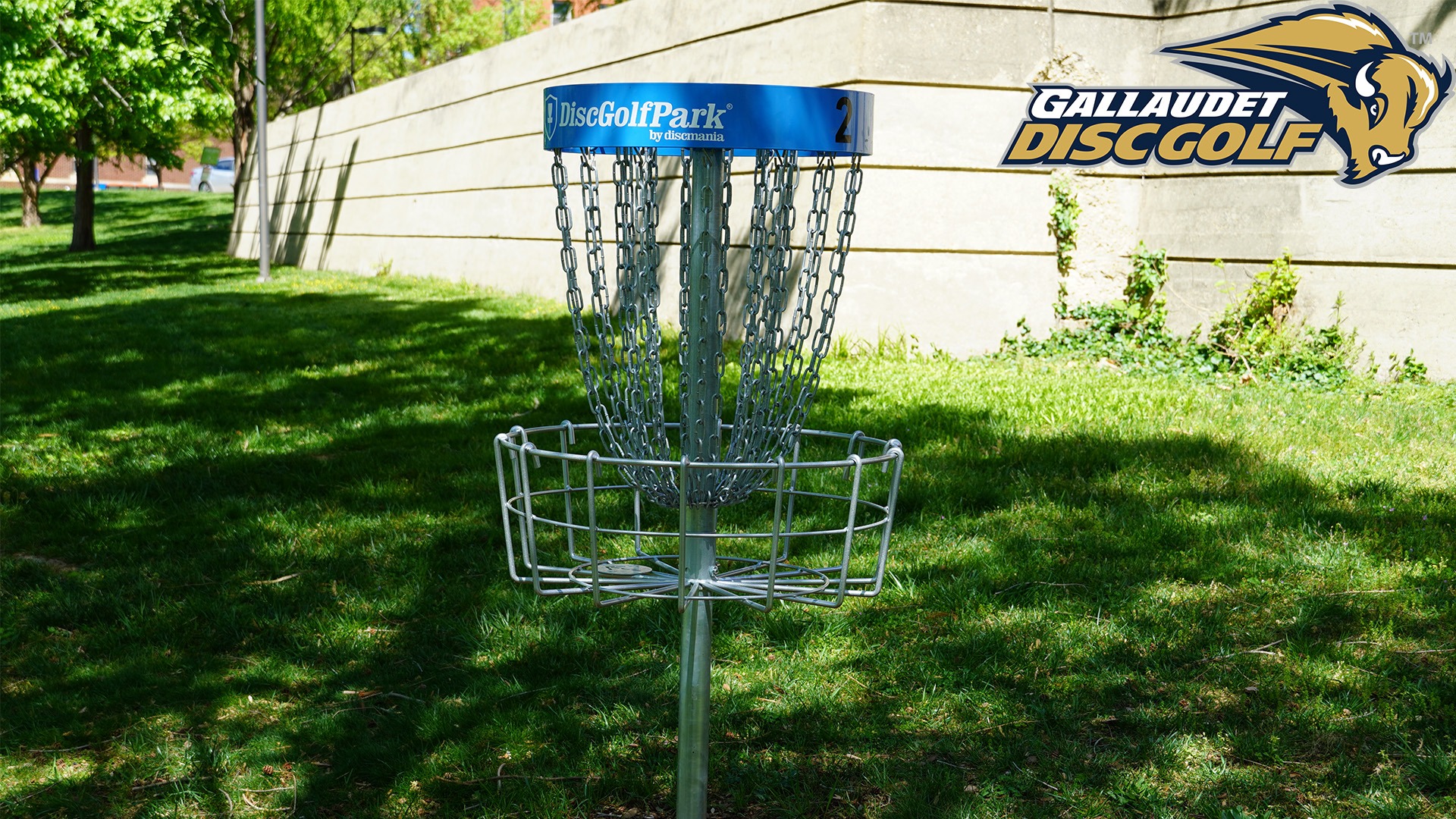 A disc golf blue basket with logo of Gallaudet disc golf