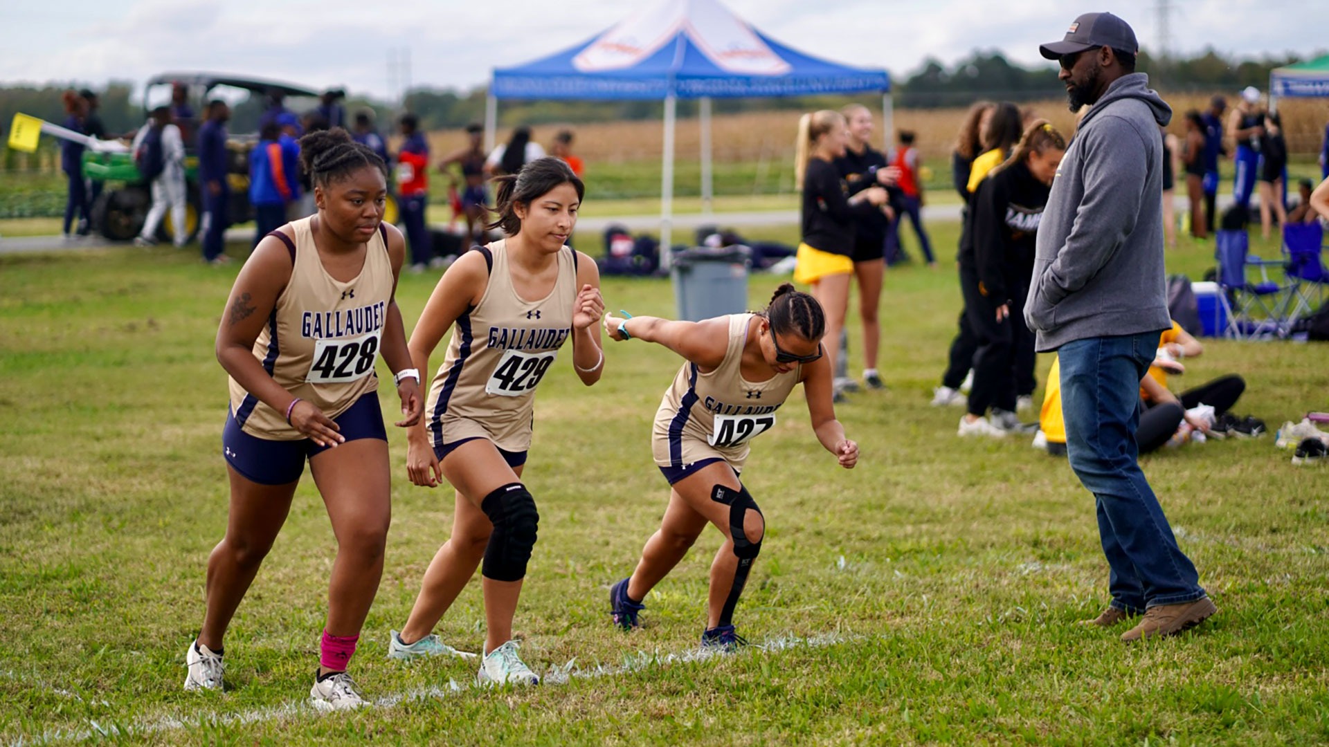 Gallaudet women's cross country runners toe the starting line before an afternoon meet in Virginia.