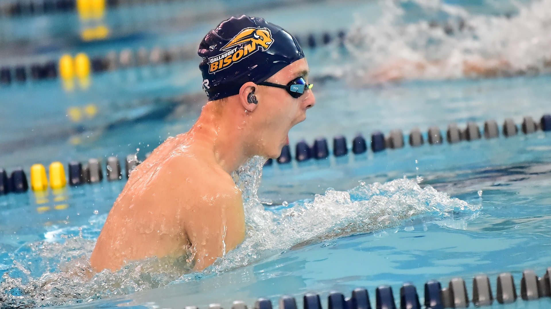 Gallaudet men's swimmer Alex Wilding performs the breaststroke in the pool during a meet.