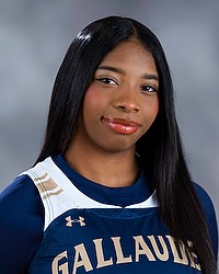 Shanice Walters - 2025-26 Gallaudet women’s basketball headshot. The Bison player wears a white basketball jersey with the word Gallaudet across the chest and looks towards the camera. A gray backdrop is in the background.