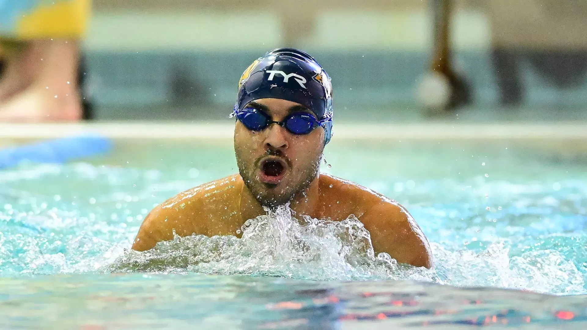 Gallaudet men's swimmer Driss Oukake performs the breaststroke in the pool during a meet.