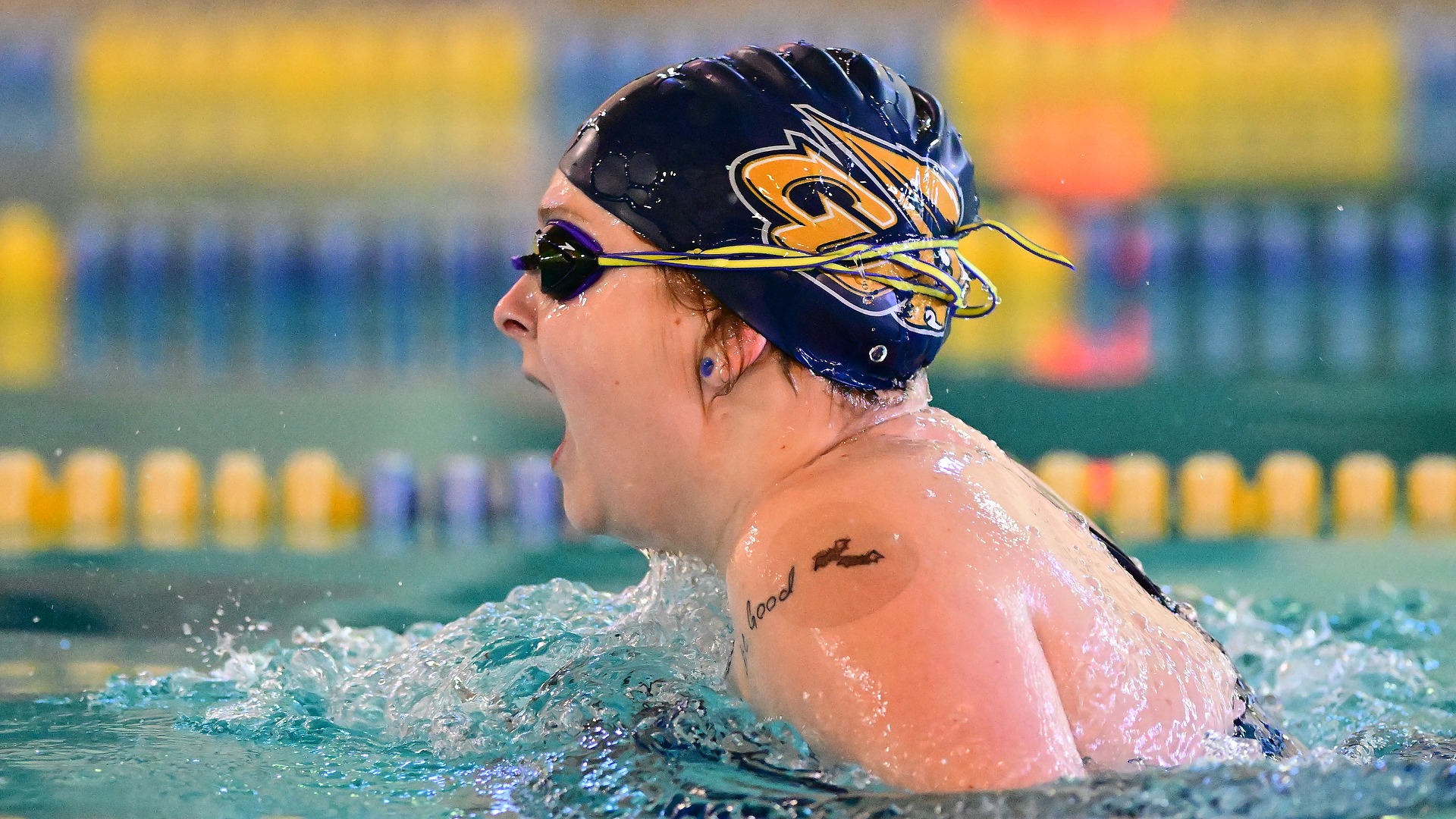 Gallaudet women's swimmer Eliza Peterson performs the breaststroke in the pool during a meet.