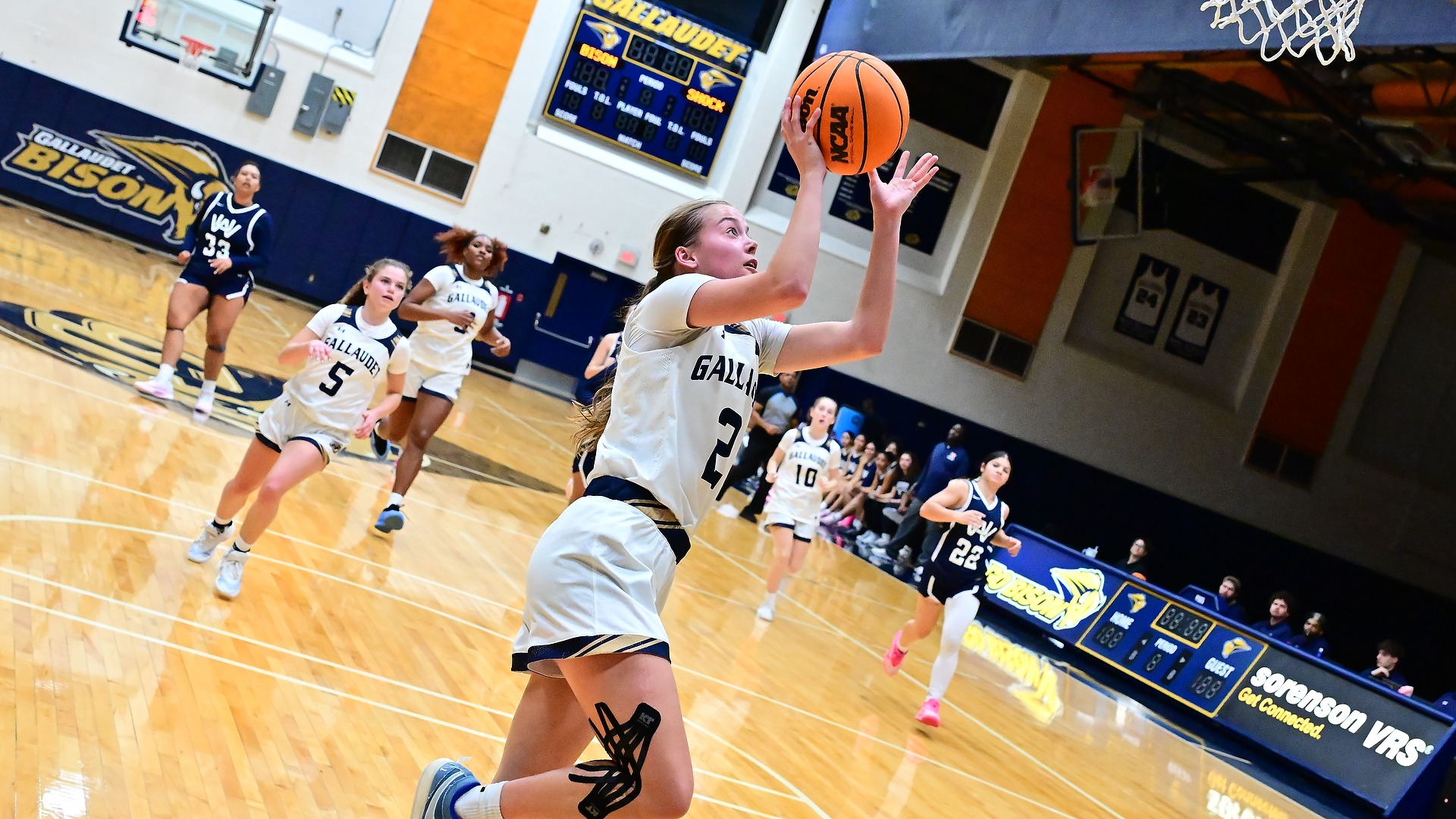 Gallaudet women's basketball player Sophia Wascher made fastbreak layup during a home game in the Field House against Washington Adventist University.