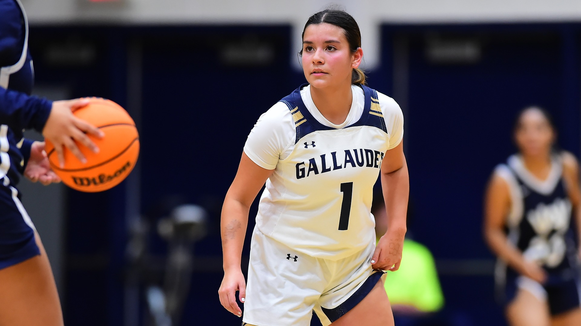 Gallaudet women's basketball player Evangeline Diaz is doing defense in close up during a home game in the Field House against Washington Adventist University.