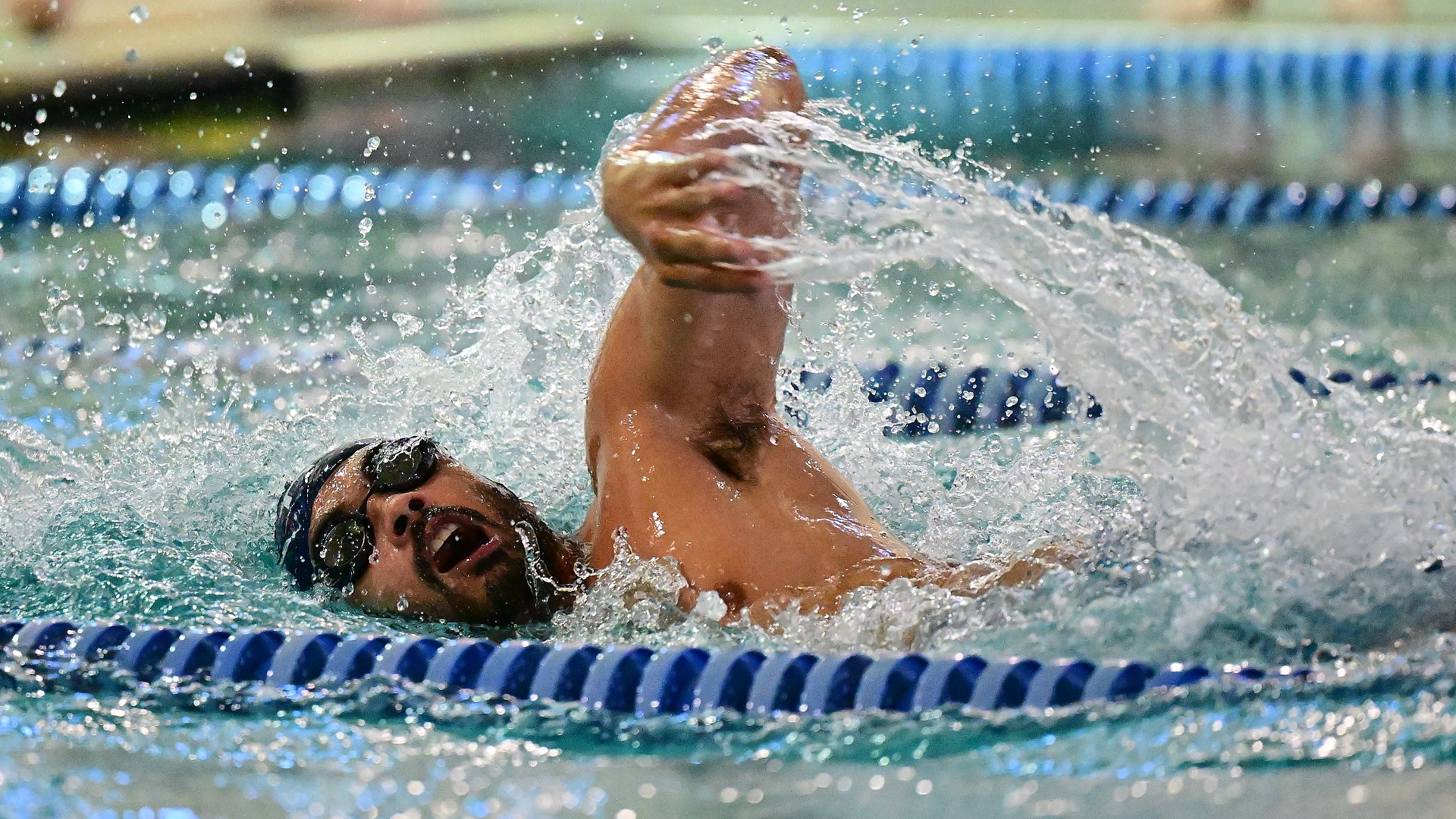 Gallaudet men's swimmer Trent Mora swims race during a home meet in the Field House pool.