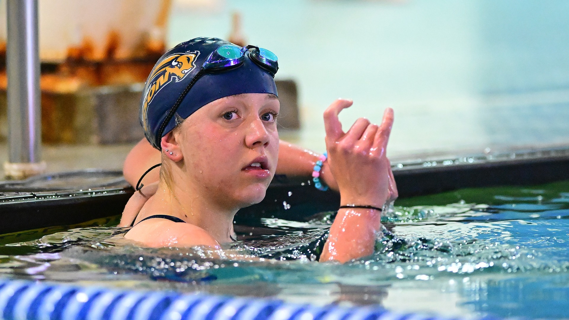 Close up of Gallaudet women's swimmer Hope MacPeek after finishing a race during a home meet in the Field House pool.