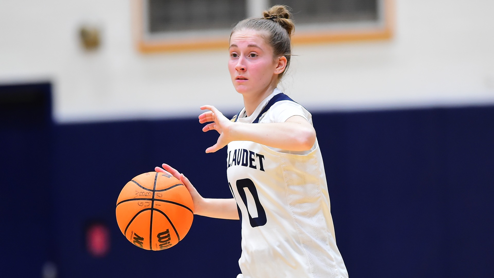 Gallaudet women's basketball player Seanna Baird is dribbling and makes the play in close up during a home game in the Field House against Washington Adventist University.