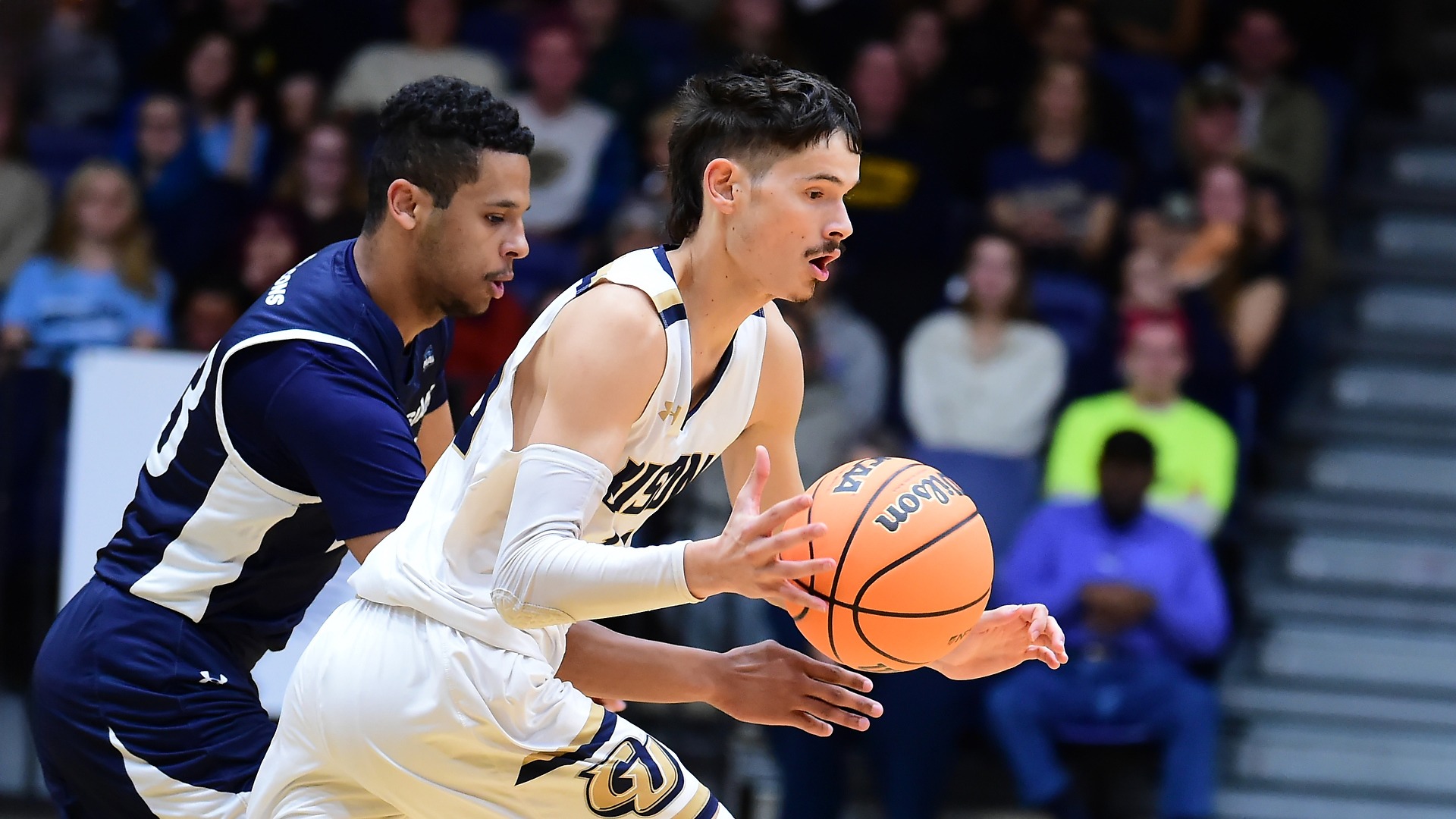Gallaudet men's basketball player Jory Valencia drives past a defender during a home game. 