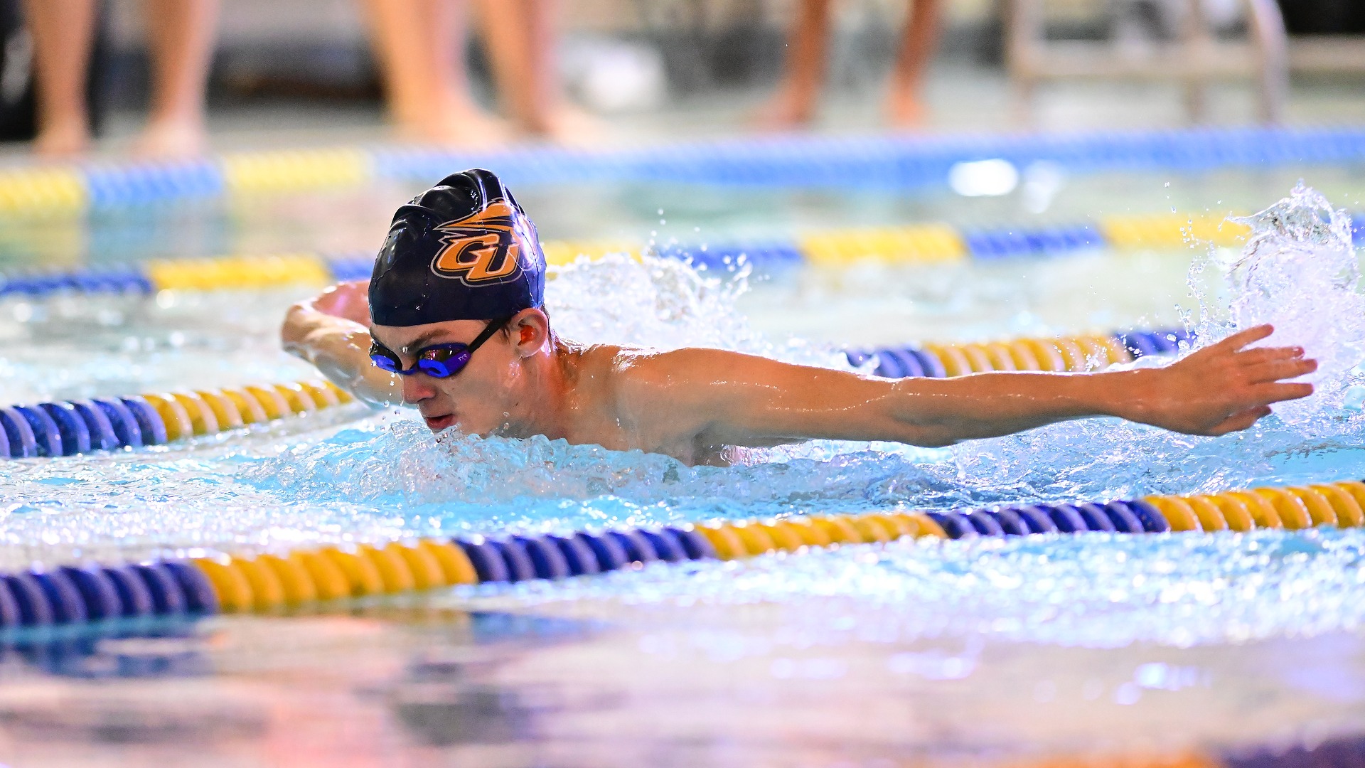 Gallaudet men's swimmer Alex Wilding performs the butterfly stroke in a home meet in the Field House pool.
