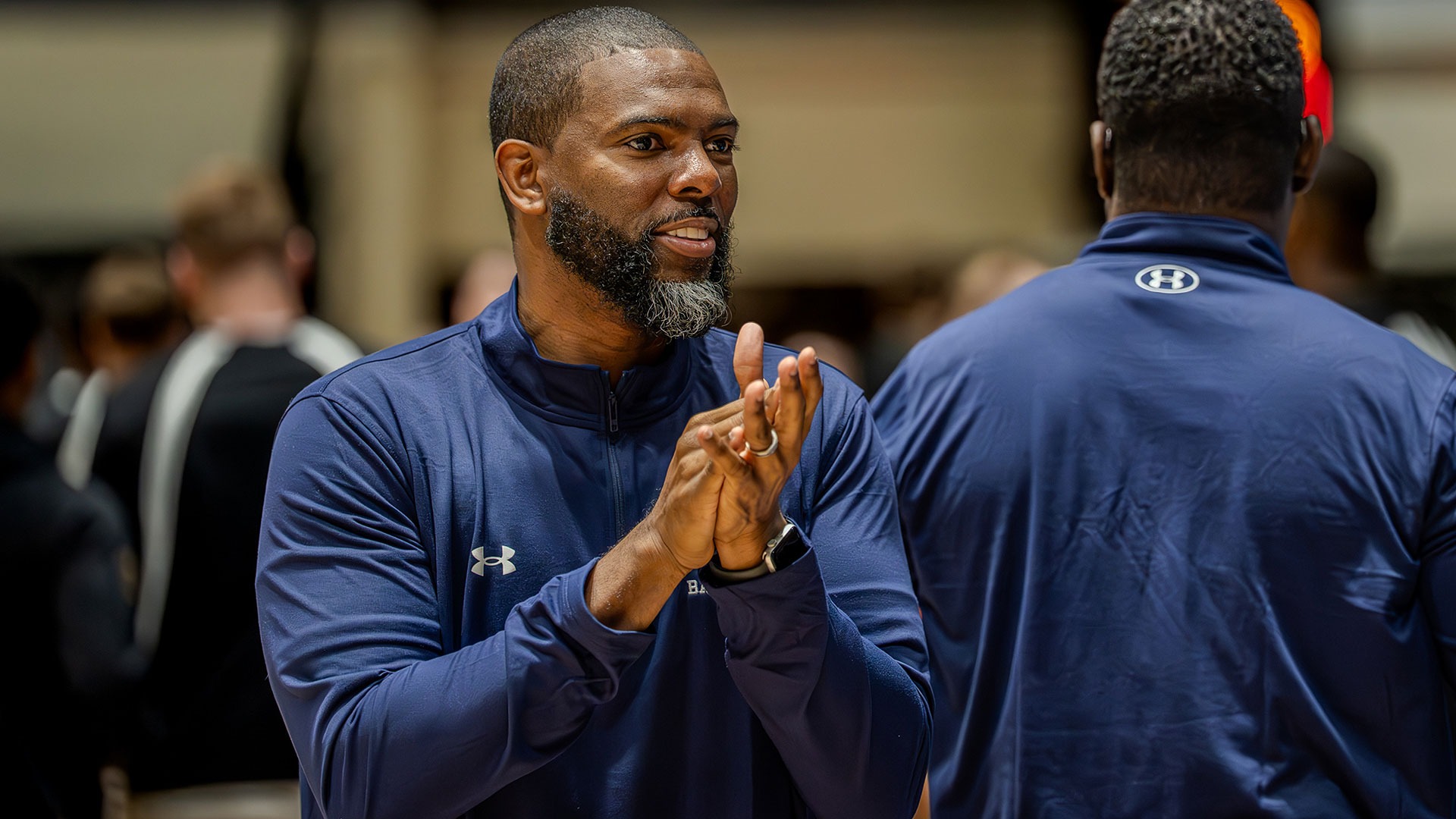 Gallaudet men's basketball coach Sekoe White claps his hand at a recent game on the road at Army West Point. 