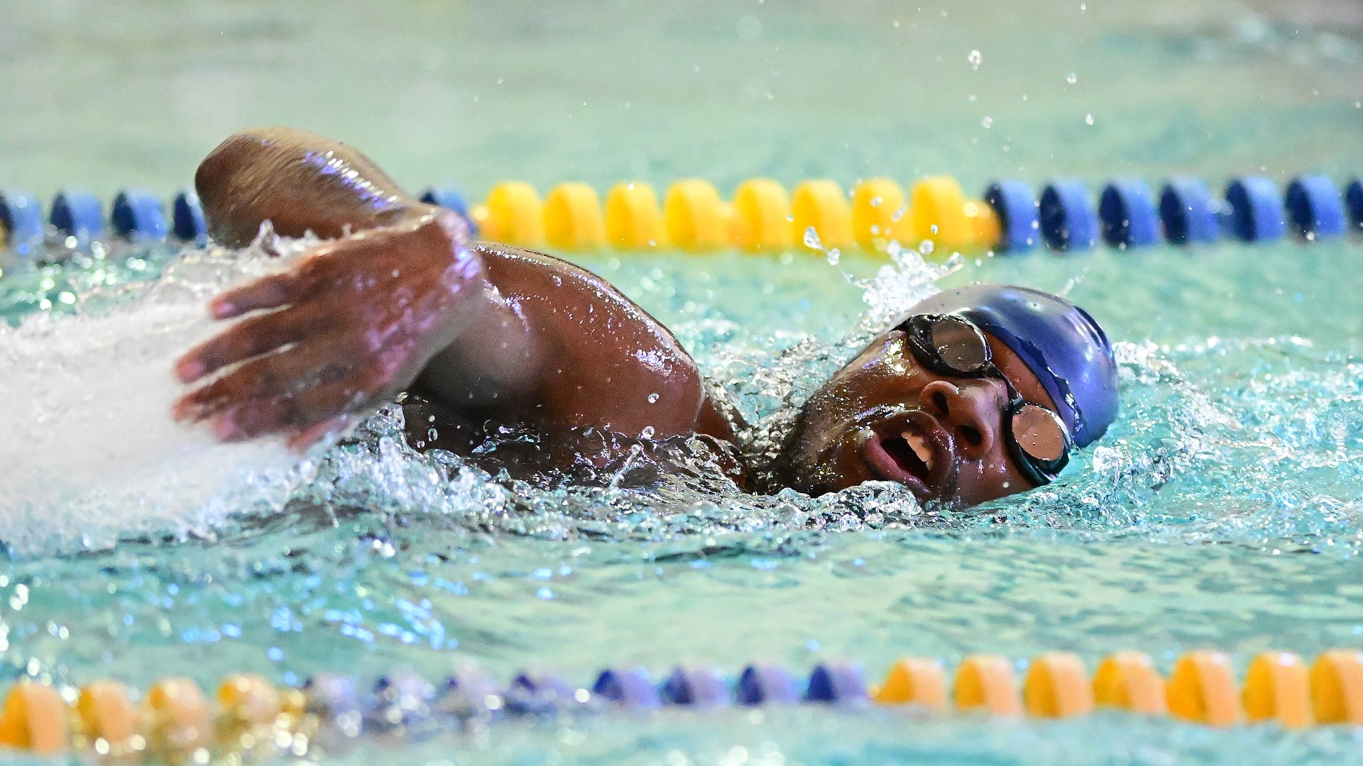 Gallaudet men's swimmer Allen Davis swims the freestyle in the Field House pool during a home meet.