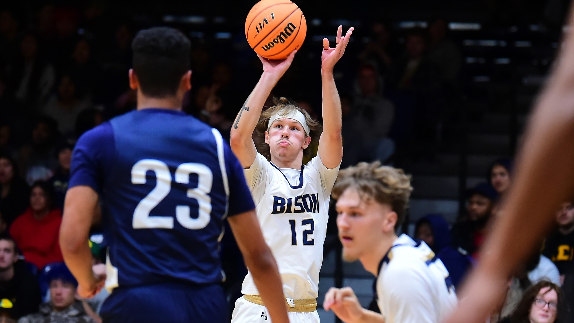Gallaudet men's basketball player Alex Ortman shoots an outside shot during a game in the Field House.